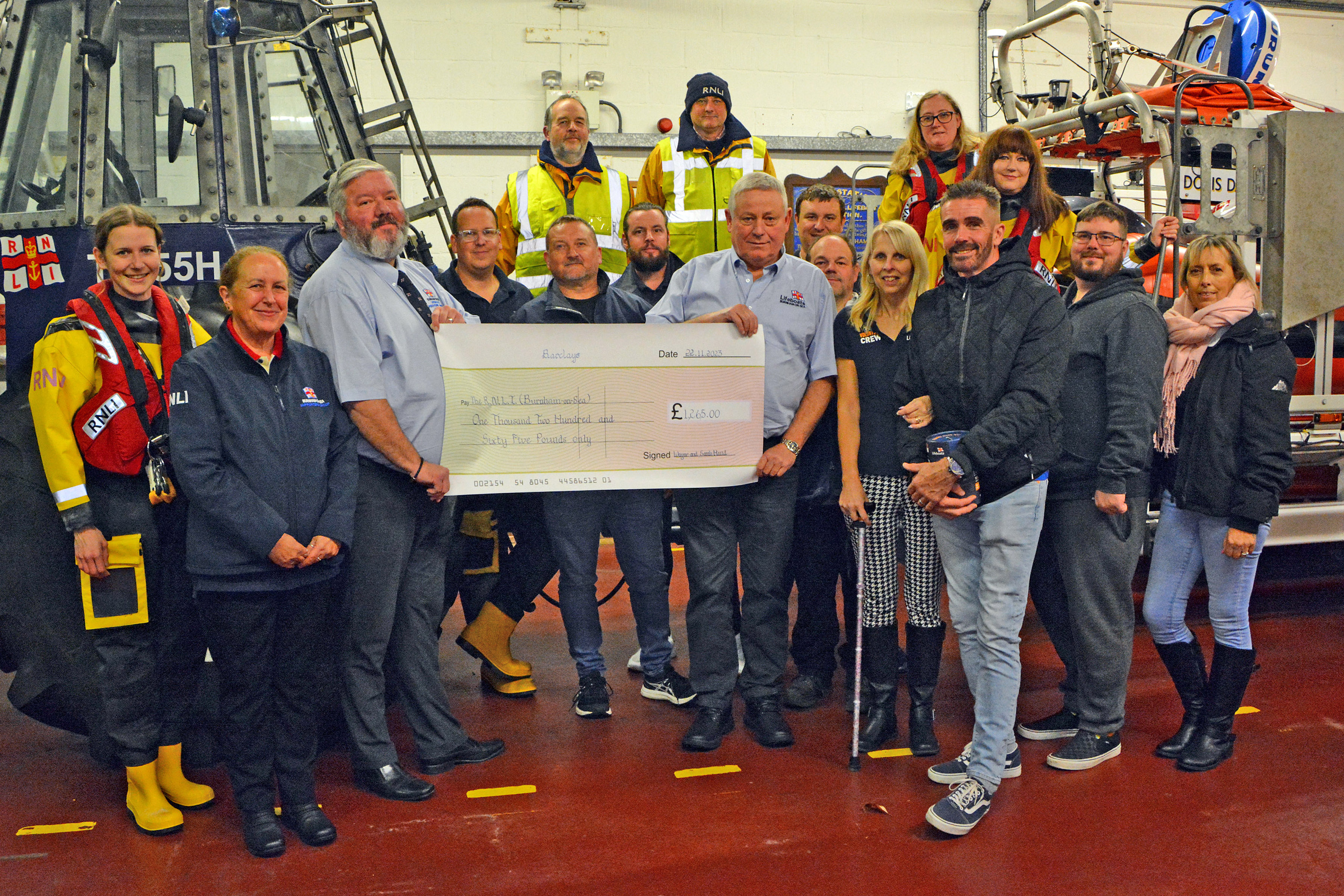 The cheque presentation with fundraisers, crewmembers, Sarah and husband Wayne
