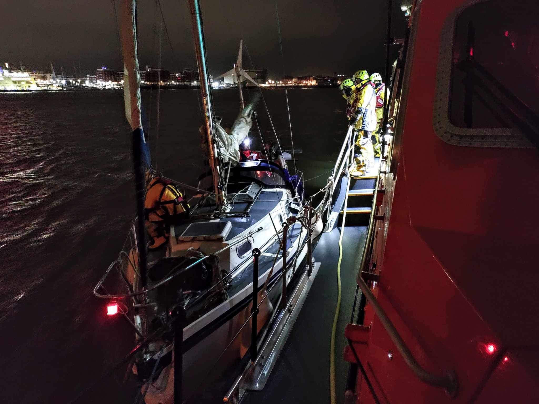 Photo of the disabled yacht alongside RNLB Alfred Albert Williams entering Portsmouth Harbour