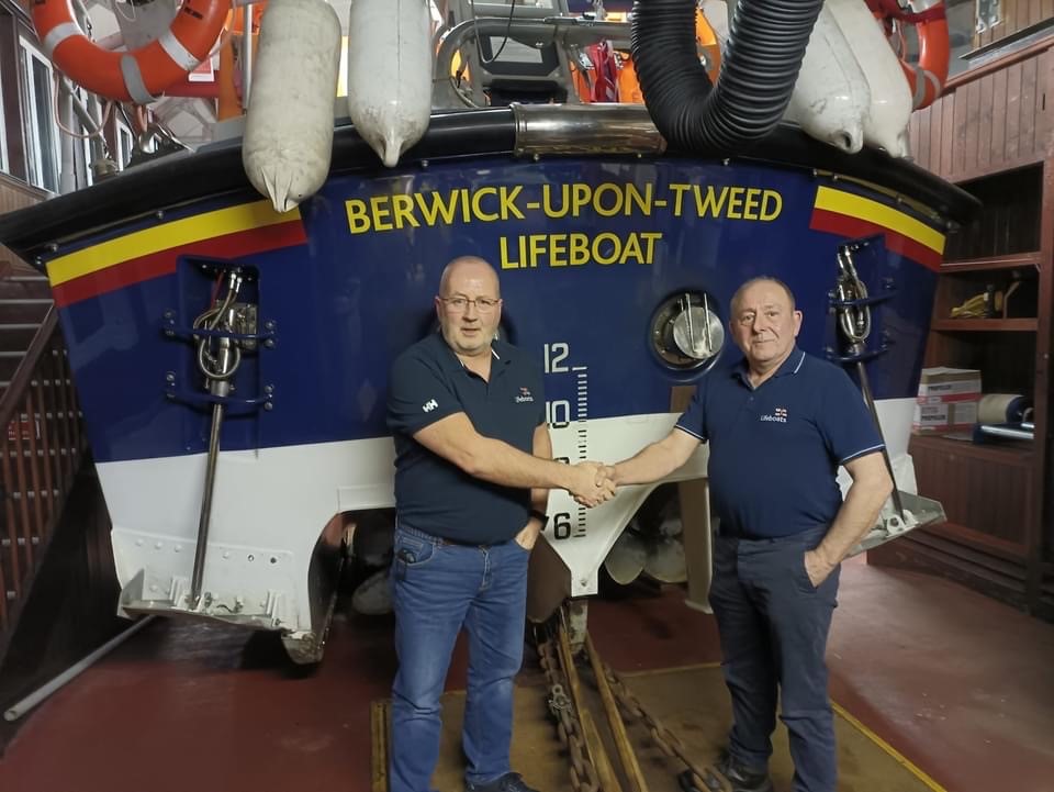 Retiring Lifeboat Operations Manager handing over to Kevin Knox as new Lifeboat Operations Manager