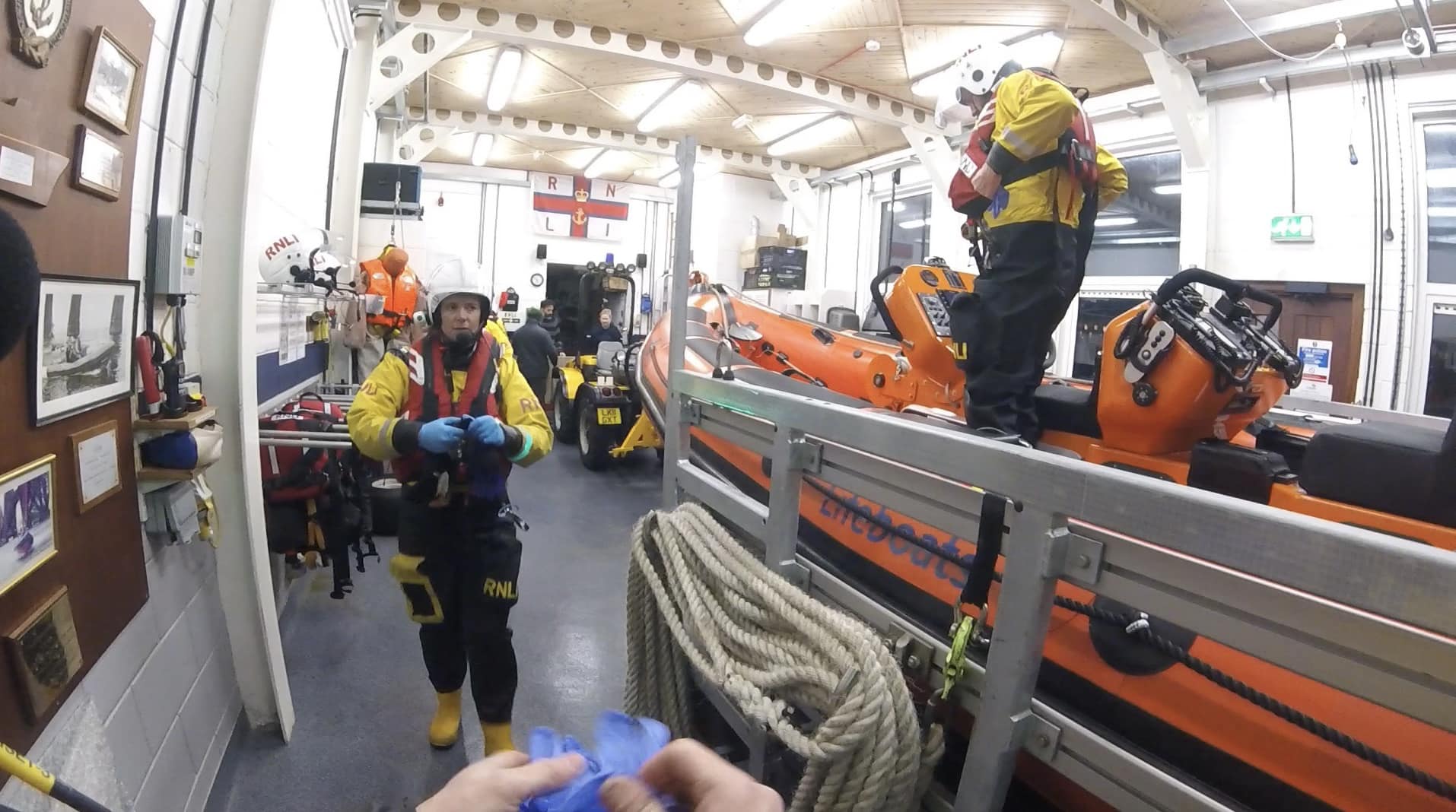 The crew getting themselves and the lifeboat kitted up for launching on service in the boat shed.