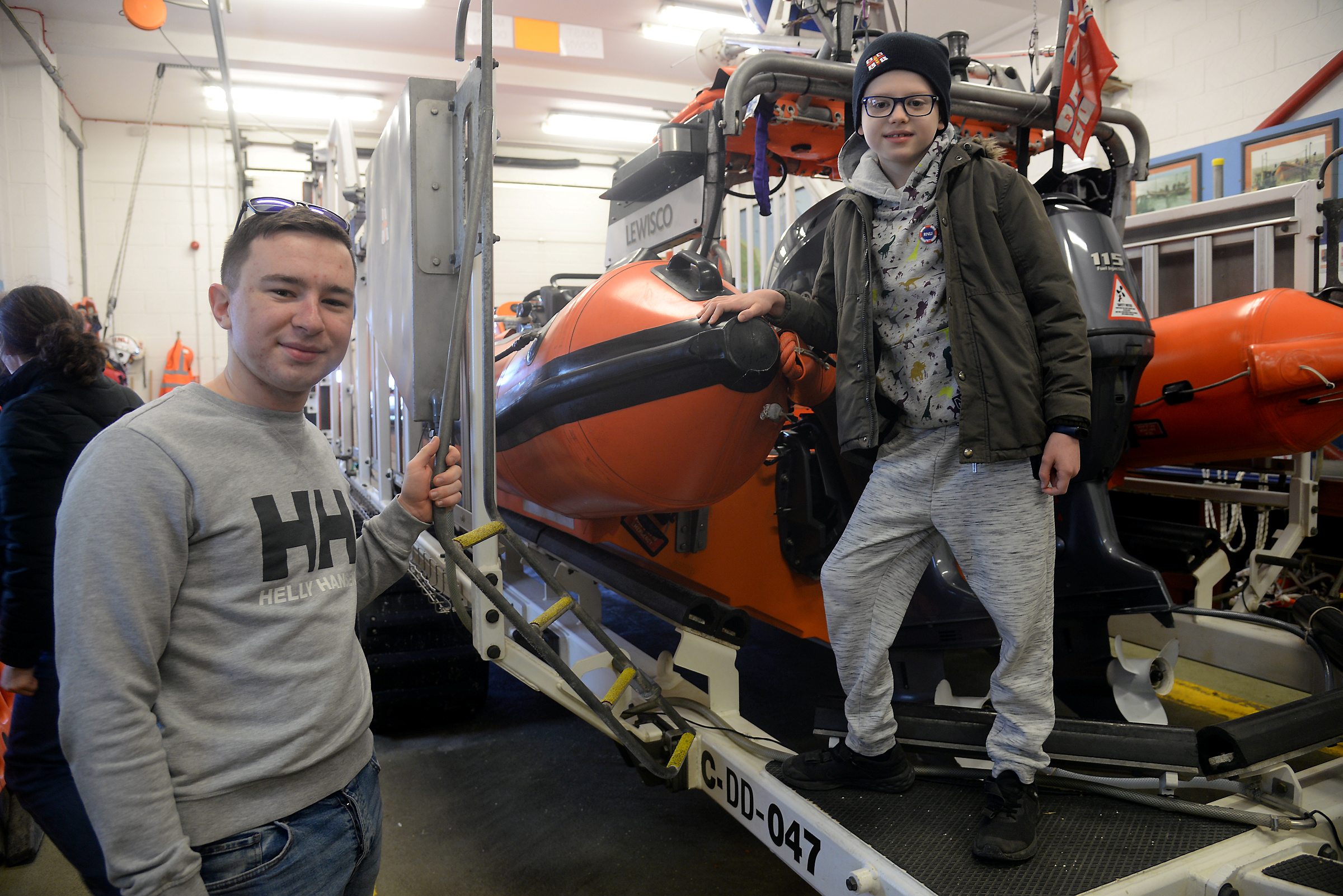 Whitstable lifeboat crewmember Ollie Myhill shows Stan Millar, nine around the lifeboat station.