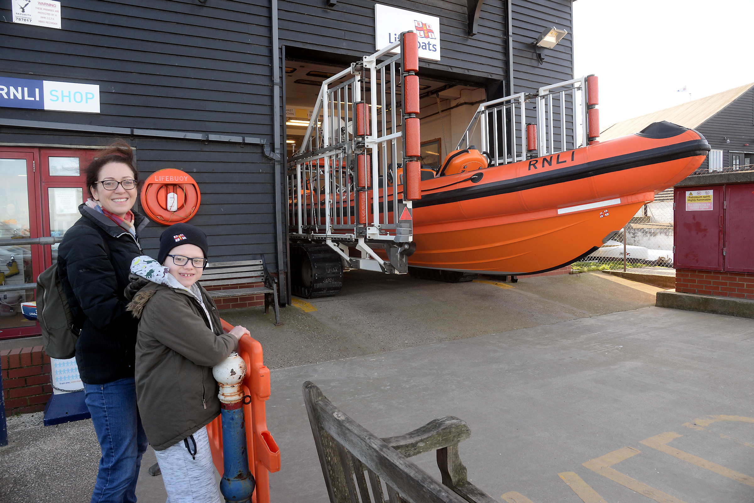 Stan Millar, nine and his Mum Anna watch as Whitstable lifeboat emerges from the boat hall.