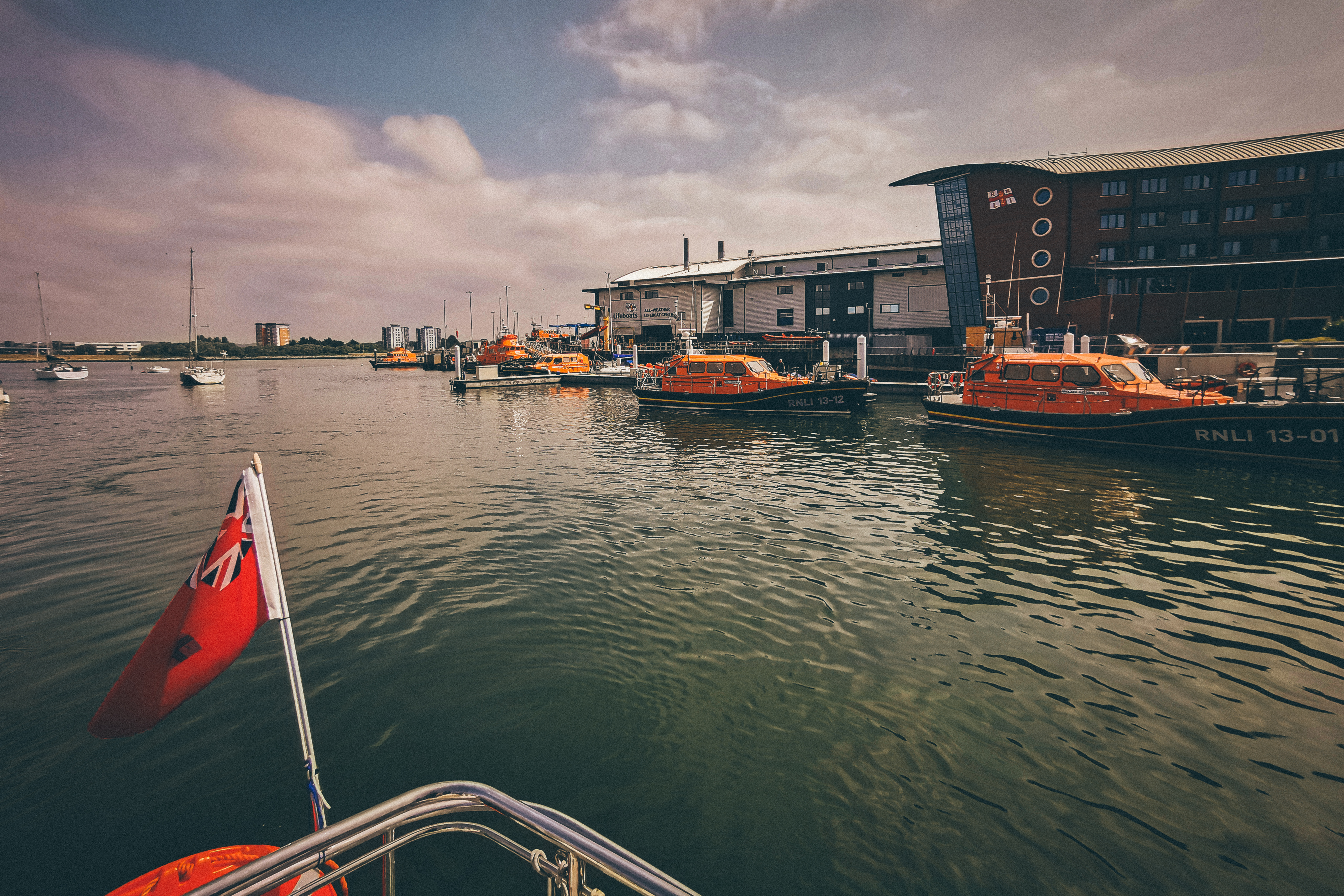 Several all weather lifeboats moored up at the lifeboat training centre RNLI college, Poole