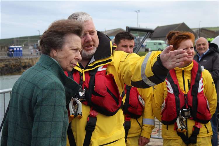 "Buckie? It's over there, Ma'am". Coxswain Davie Grant in conversation with HRH Princess Anne, with navigator Louise Cooper looking on