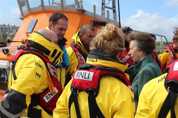 HRH Princess Anne talks to volunteer members of the Buckie lifeboat crew, with the town's Severn class lifeboat 'William Blannin' behind