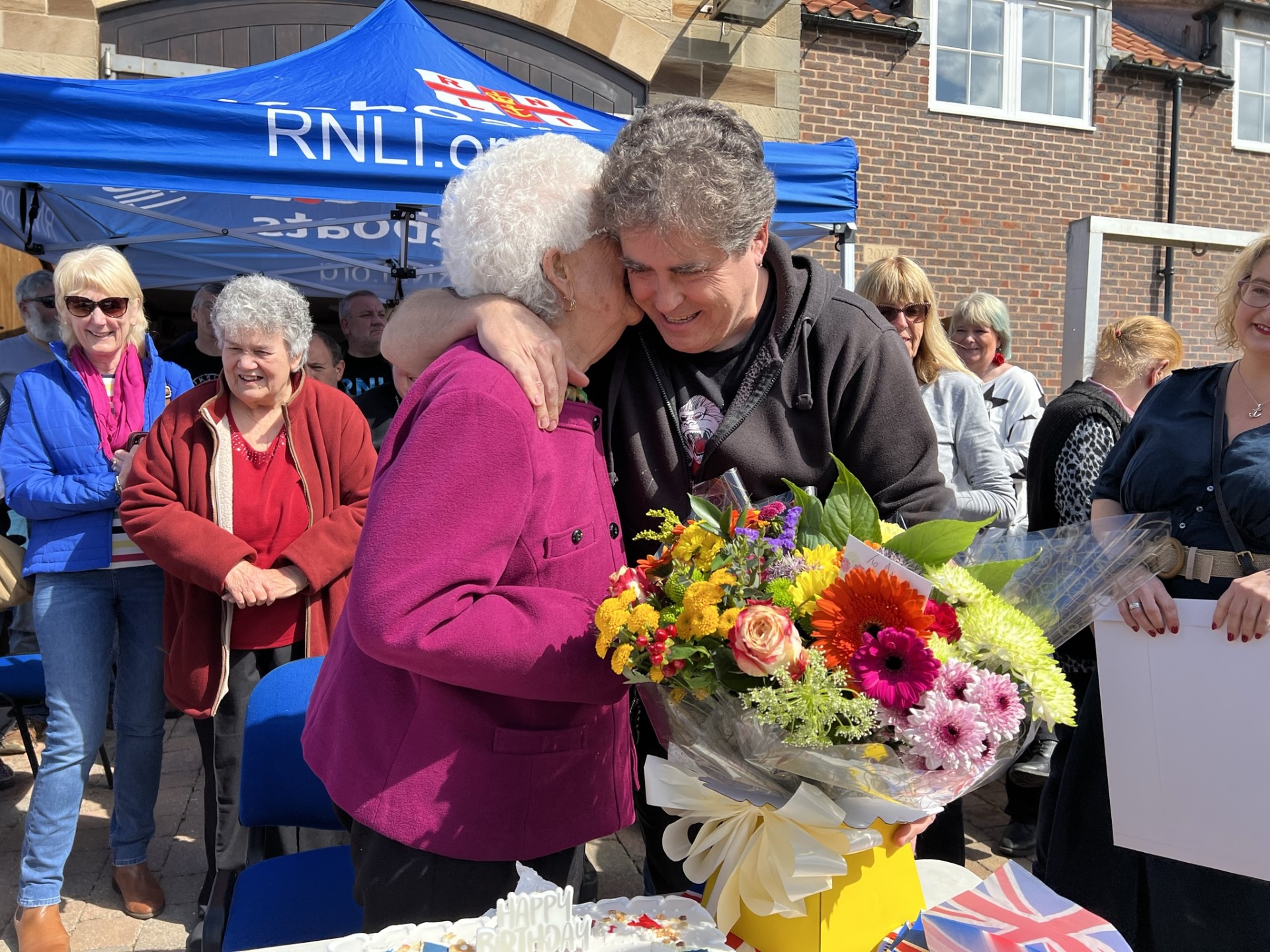 Crew member Geoff Hodgson presents Ada with flowers from the crew.