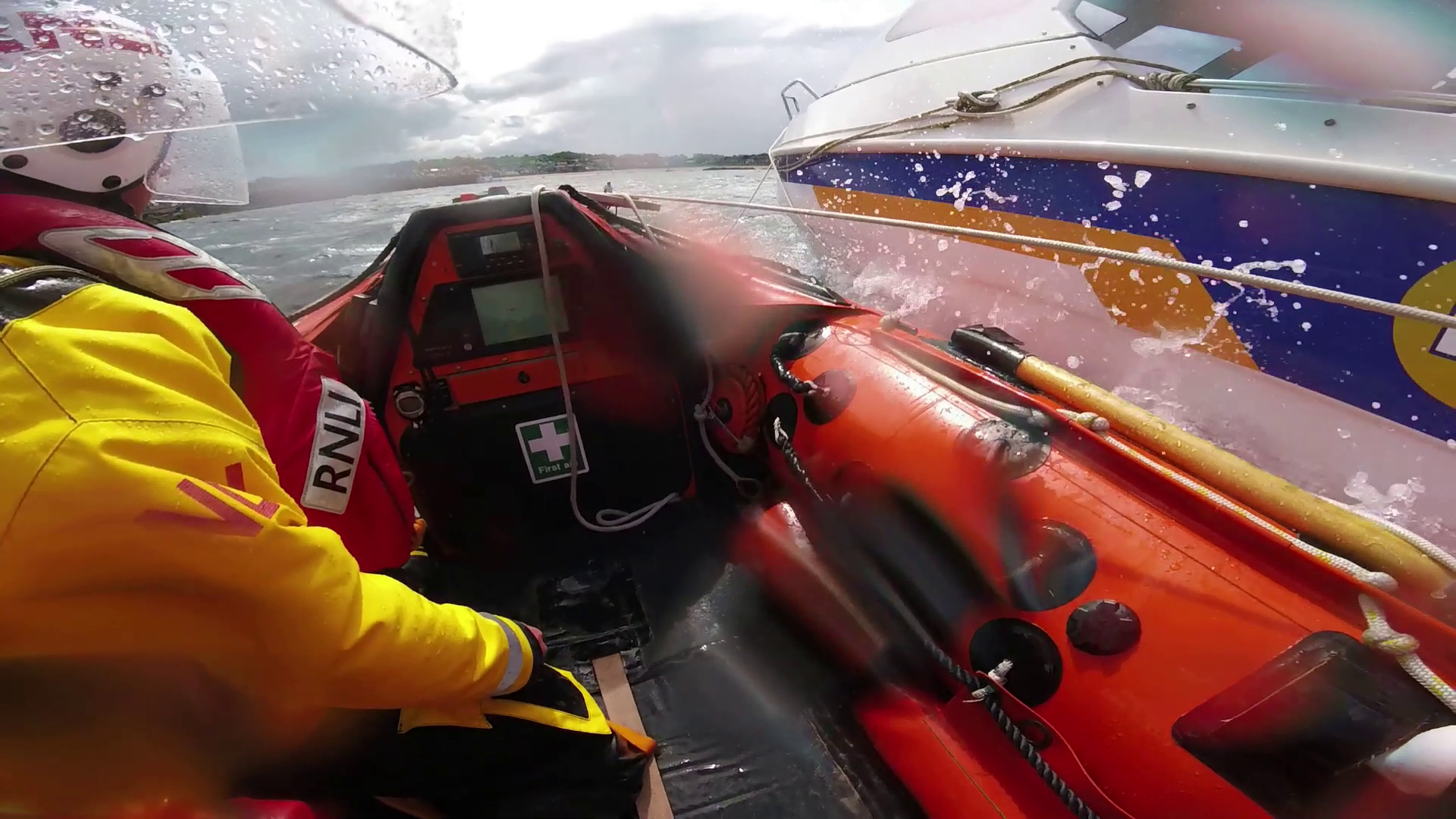 Crew members on the TNLI lifeboat during an alongside tow