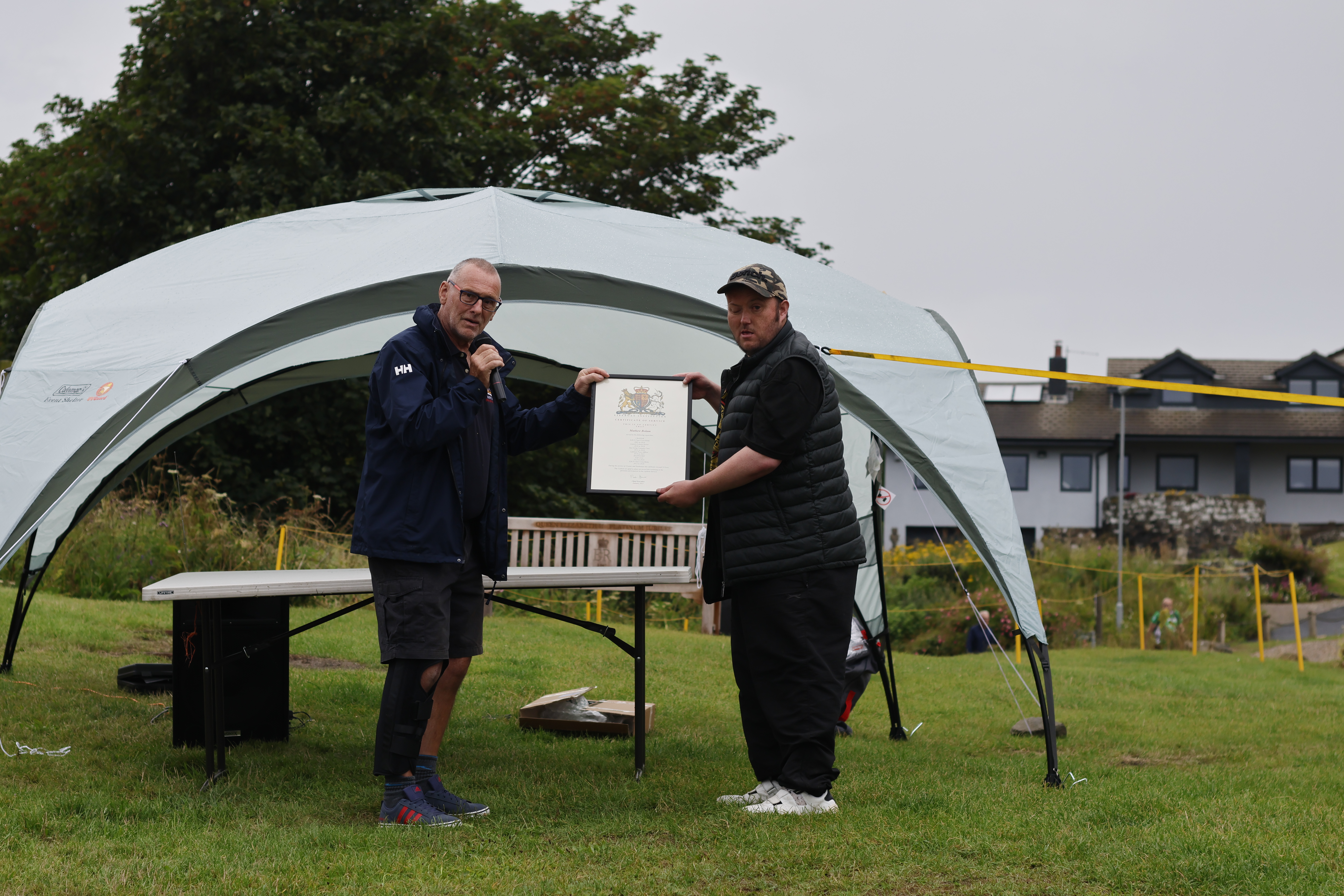 Mathew Bolam being presented by lifeboat operations manager Kev Brown 