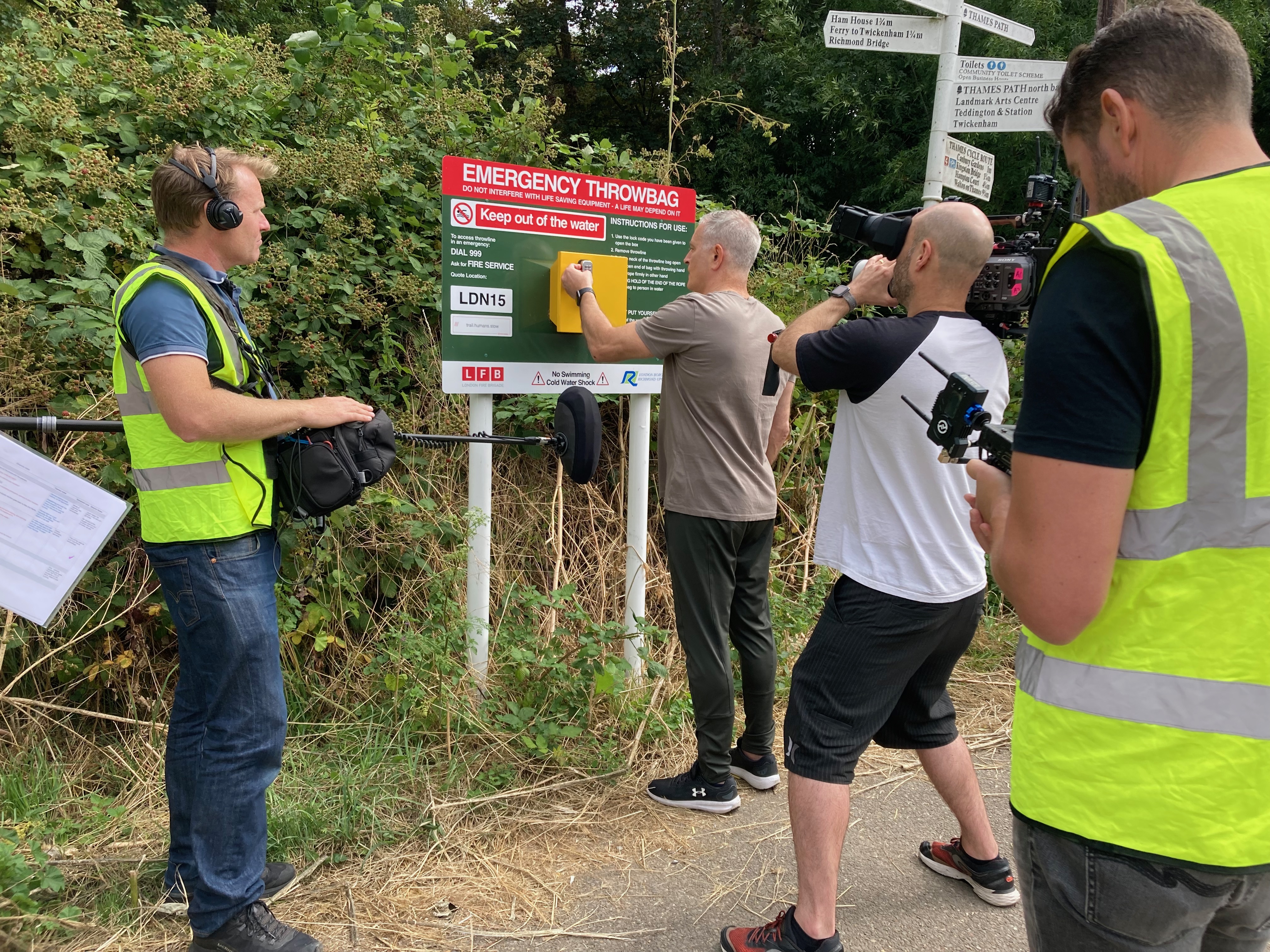 Film crew with member of public at throwbag board