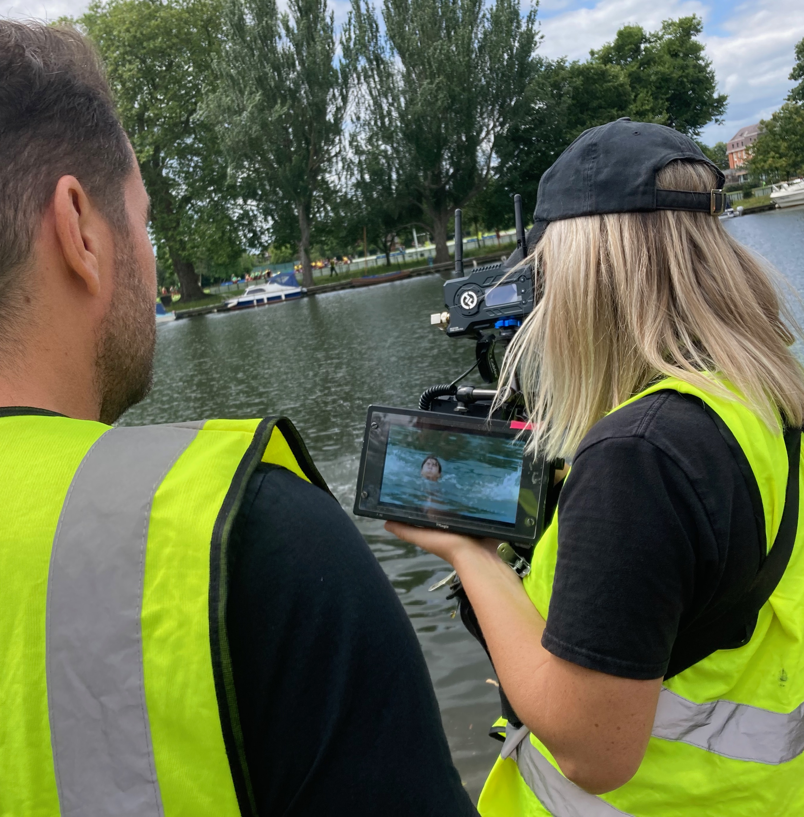 Two crew reviewing film of person in the water