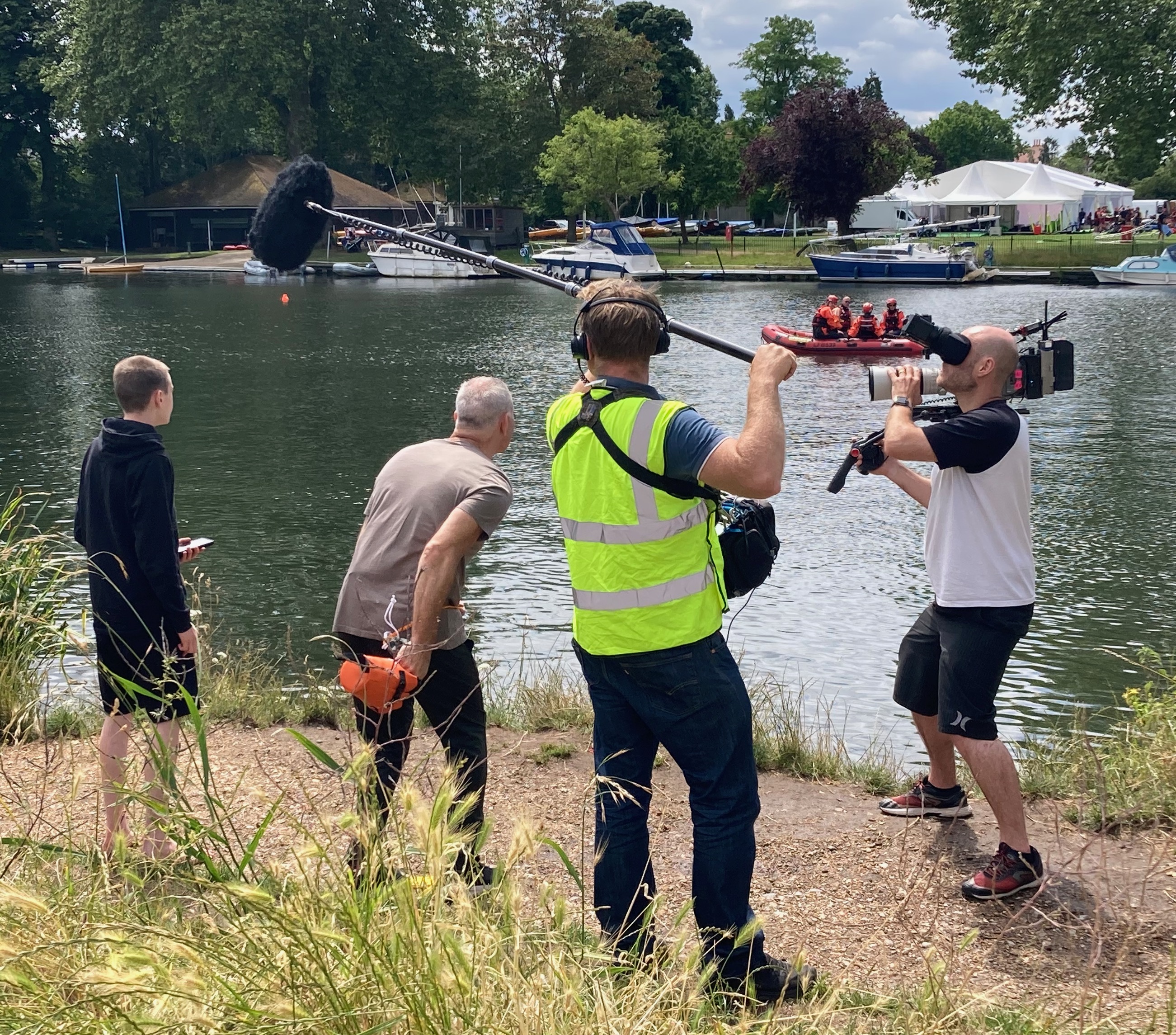 Crew with man throwing throwbag and safety boat in shot