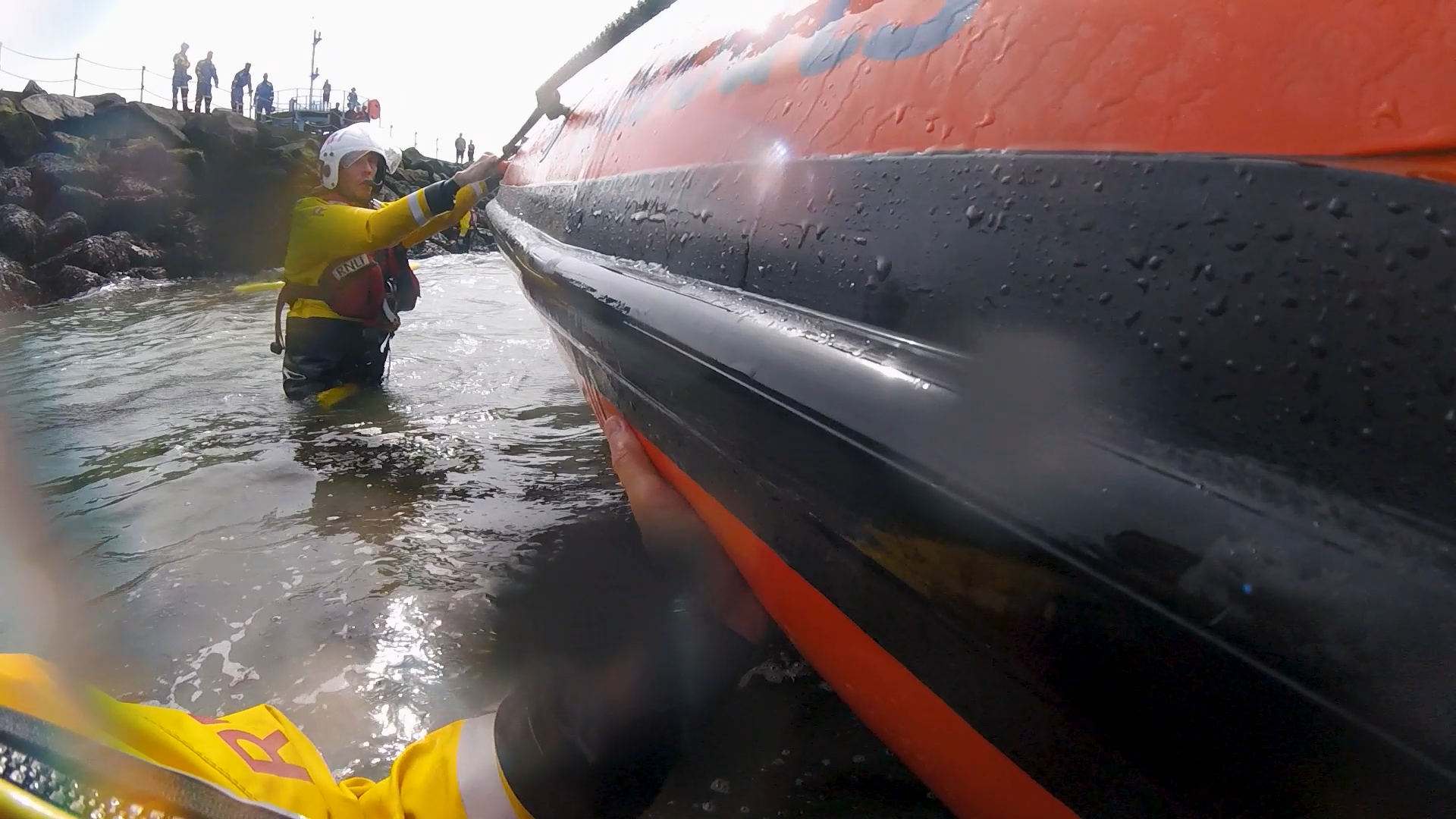 In shallow water crewmembers bring the lifeboat alongside the Herne Bay harbour arm during the call to a teenage paddleboarder on the rocks on Sunday afternoon.
