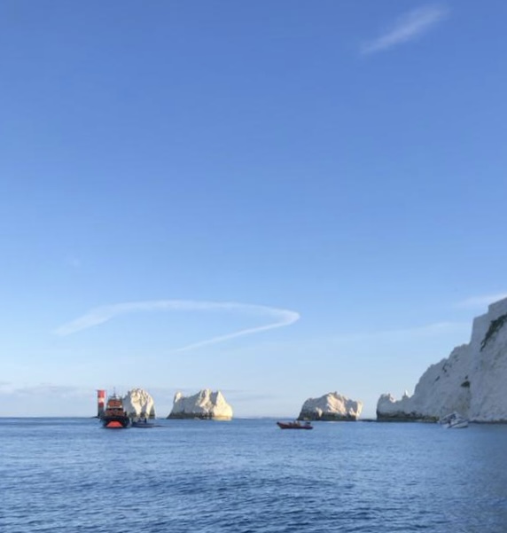The Yarmouth RNLI lifeboat, Freshwater Independent Lifeboat and a passing boat with the casualty vessel (far right)