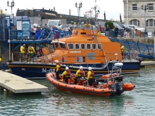 an all weather and inshore lifeboat mooring up on a pontoon.