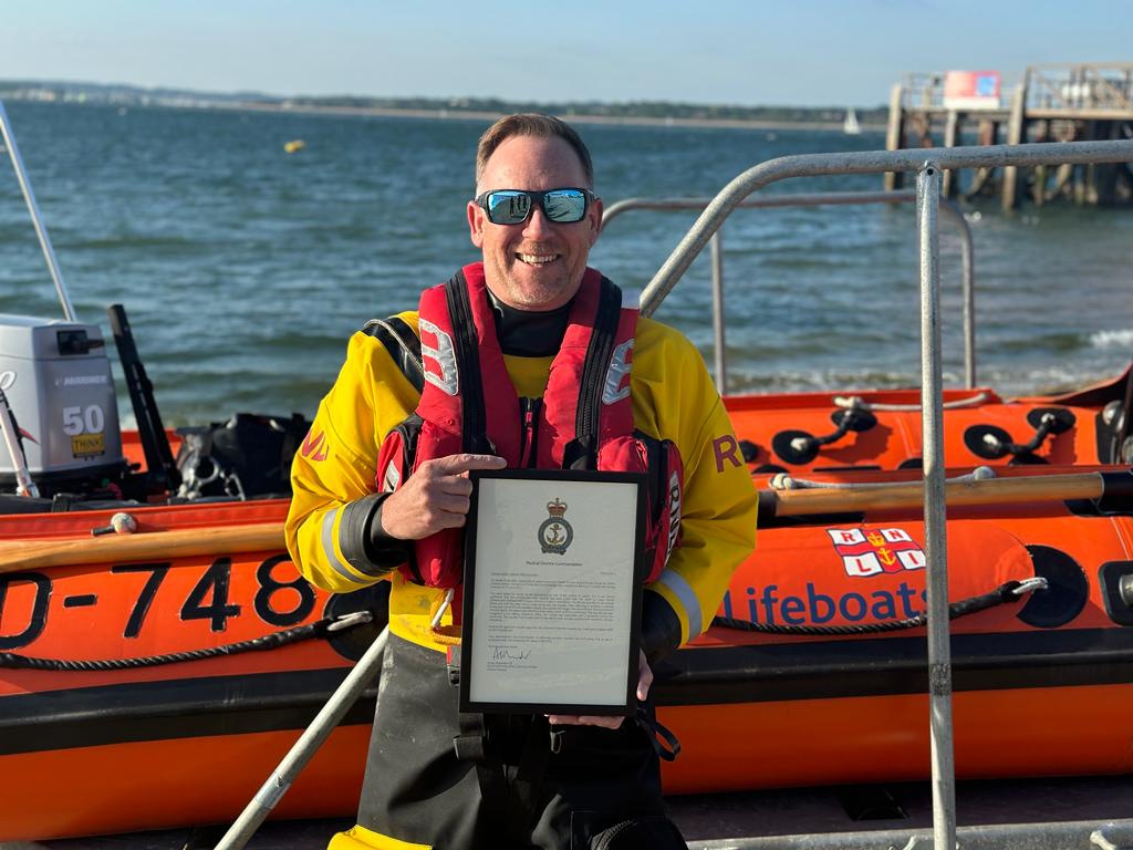 Calshot RNLI Crew Member Damian Lester with his medical director commendation