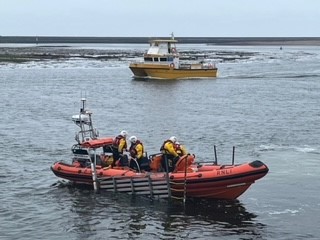 Berwick-upon-Tweed RNLI Atlantic 85 lifeboat with The Border Belle in background in search for miss child