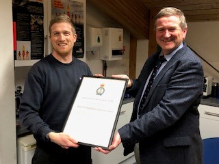Owain Williams receiving the award on behalf of Porthdinllaen Lifeboat from Mr Stuart Wallace