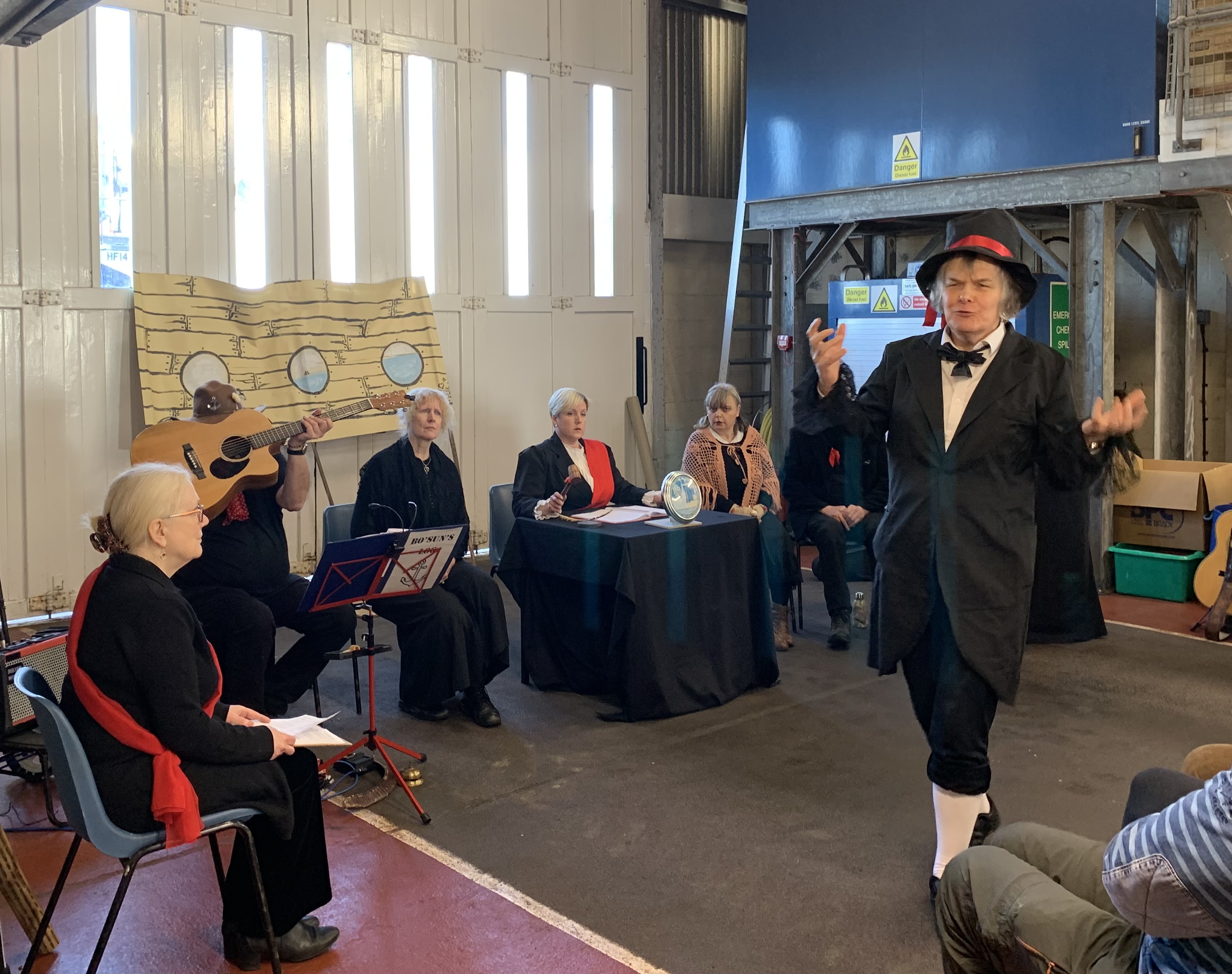 The cast performing 'The Sinking of the Northfleet' in Dungeness RNLI's boathouse.