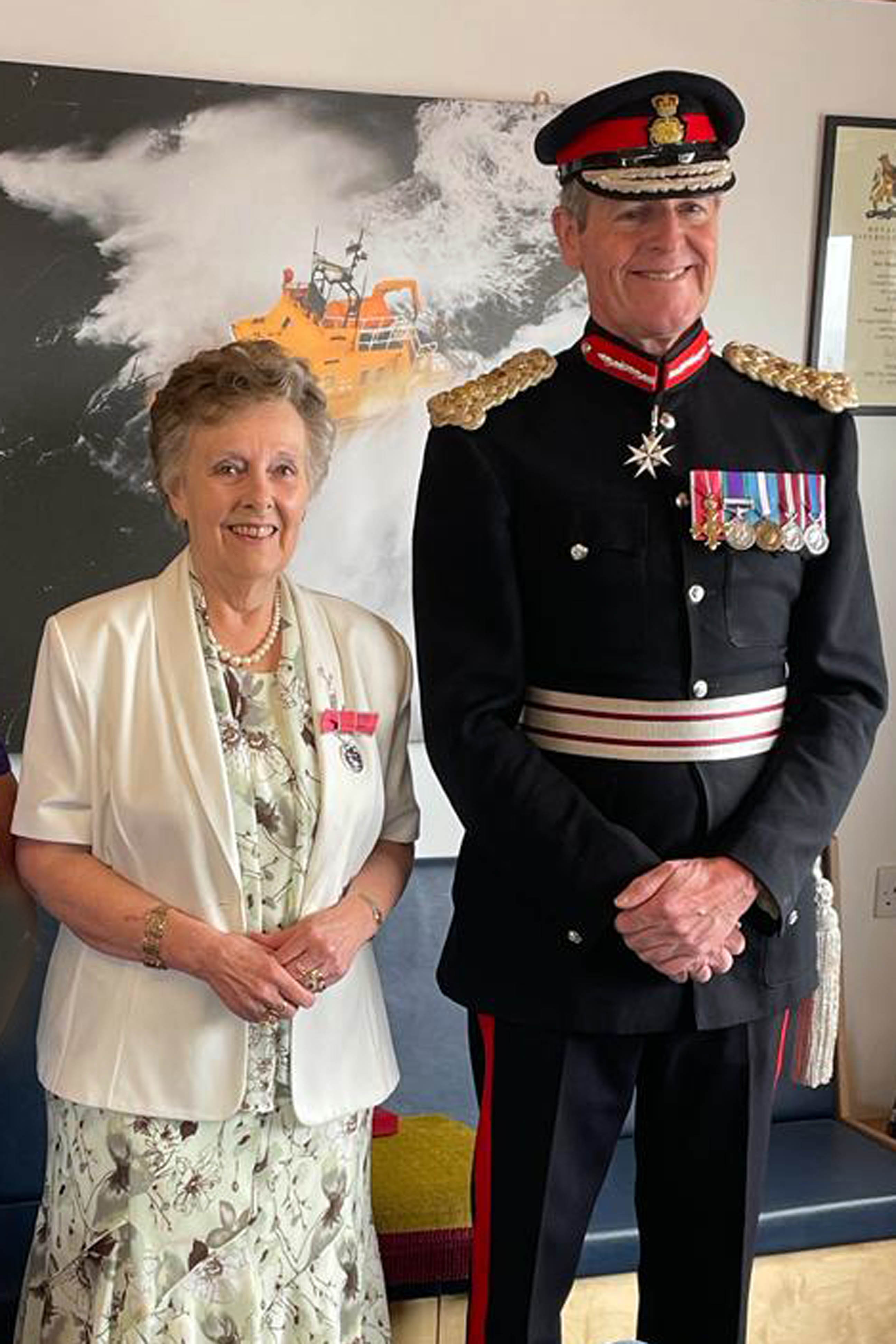 Shows lady and officer at presentation