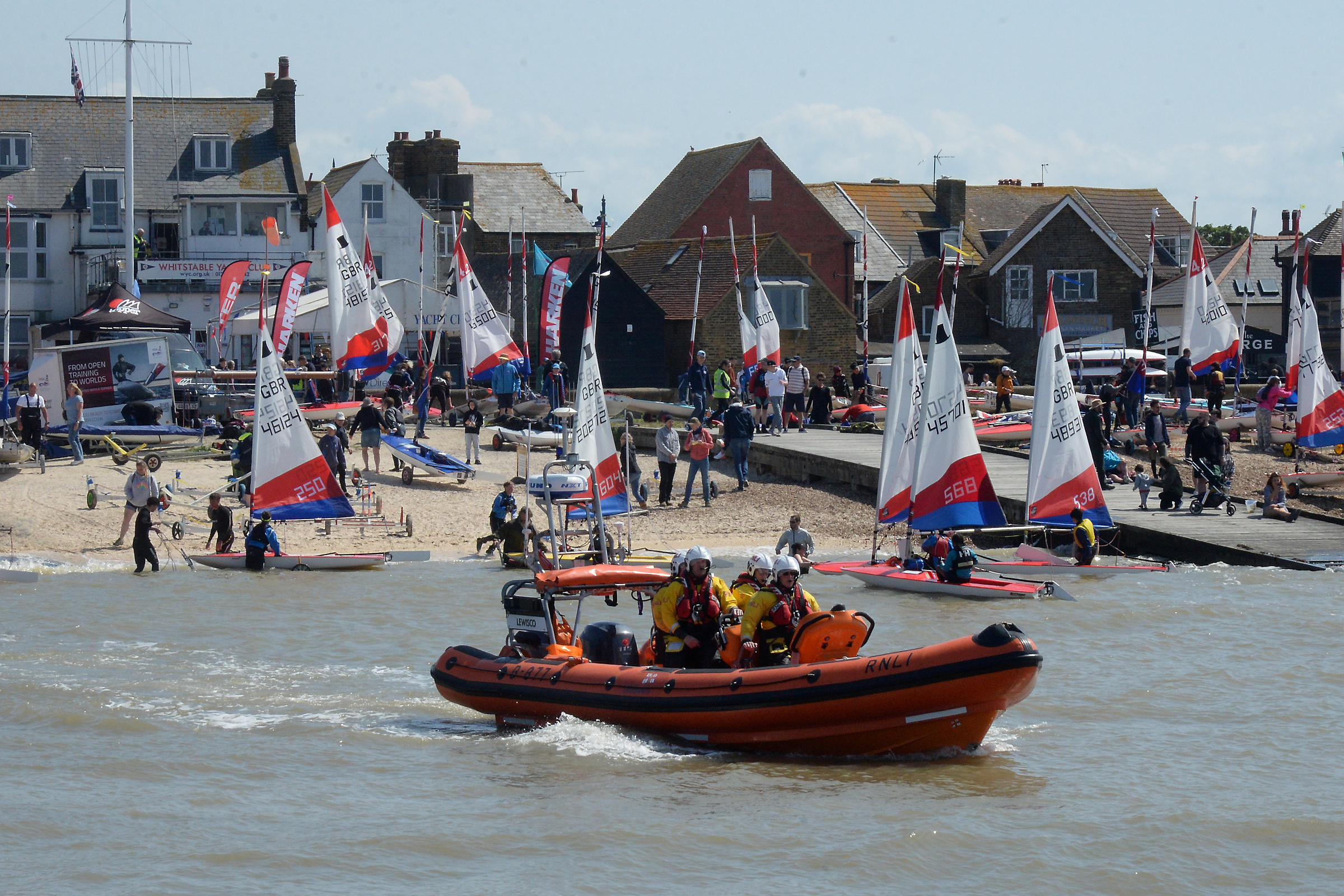 Against the backdrop of yachts and the yacht club of which Larry was president Whitstable Lifeboat heads to sea for the scattering of his ashes on Sunday afternoon. Picture: RNLI Whitstable.