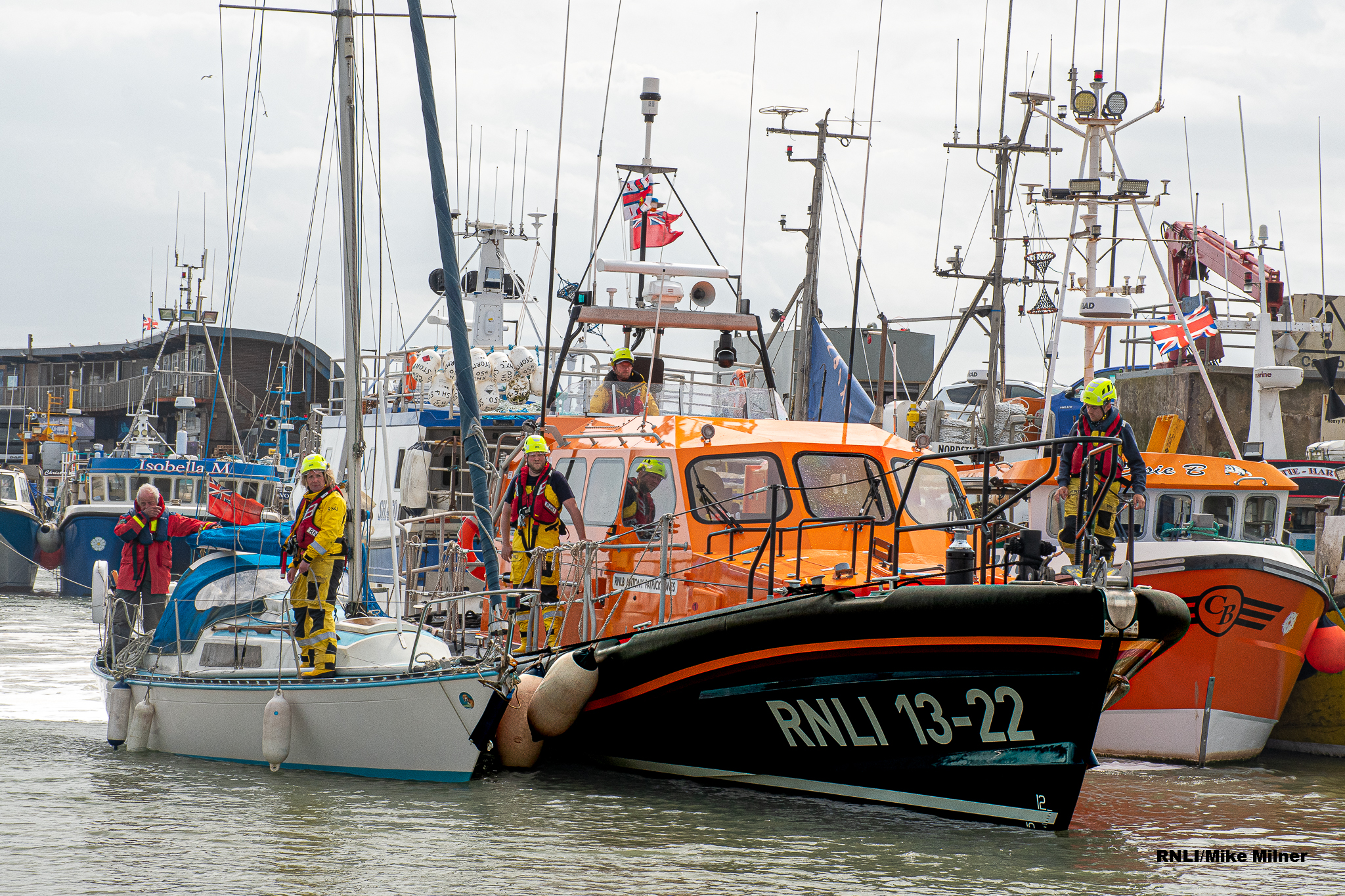 Yacht safely arrives back in Bridlington harbour with the Bridlington all-weather lifeboat.