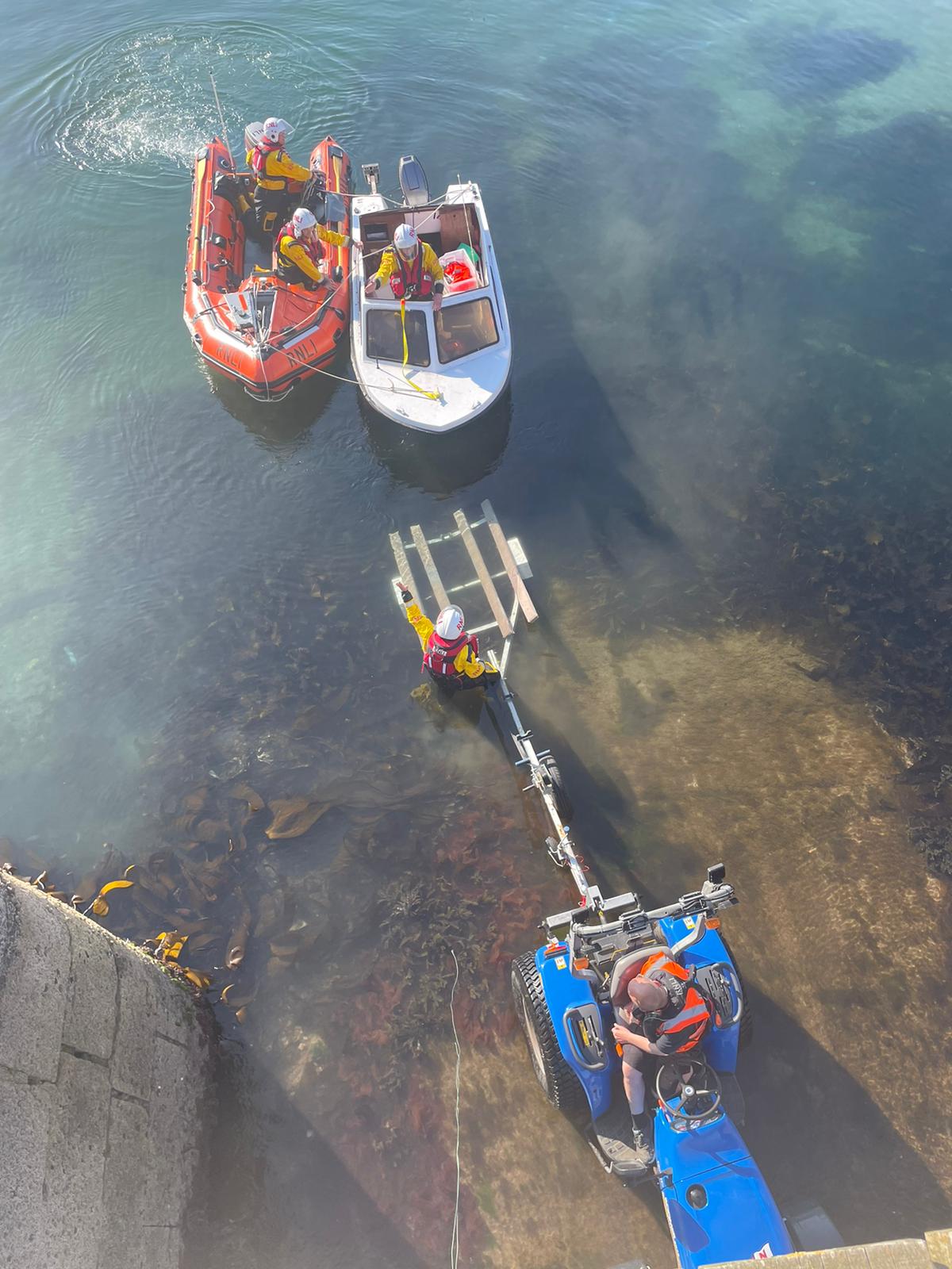 Photo shows the ILB crew manoeuvring the casualty vessel onto the trailer in Dunbar Harbour.
