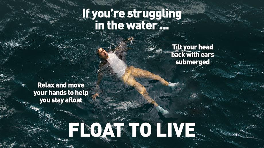 Someone floating on their back with their arms outstretched floating to live