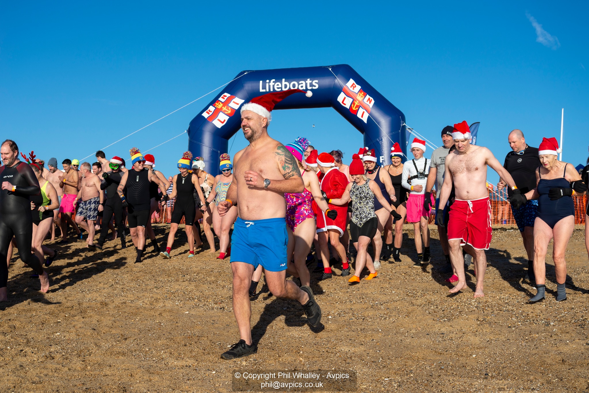 Brave fundraisers running into the cold sea
