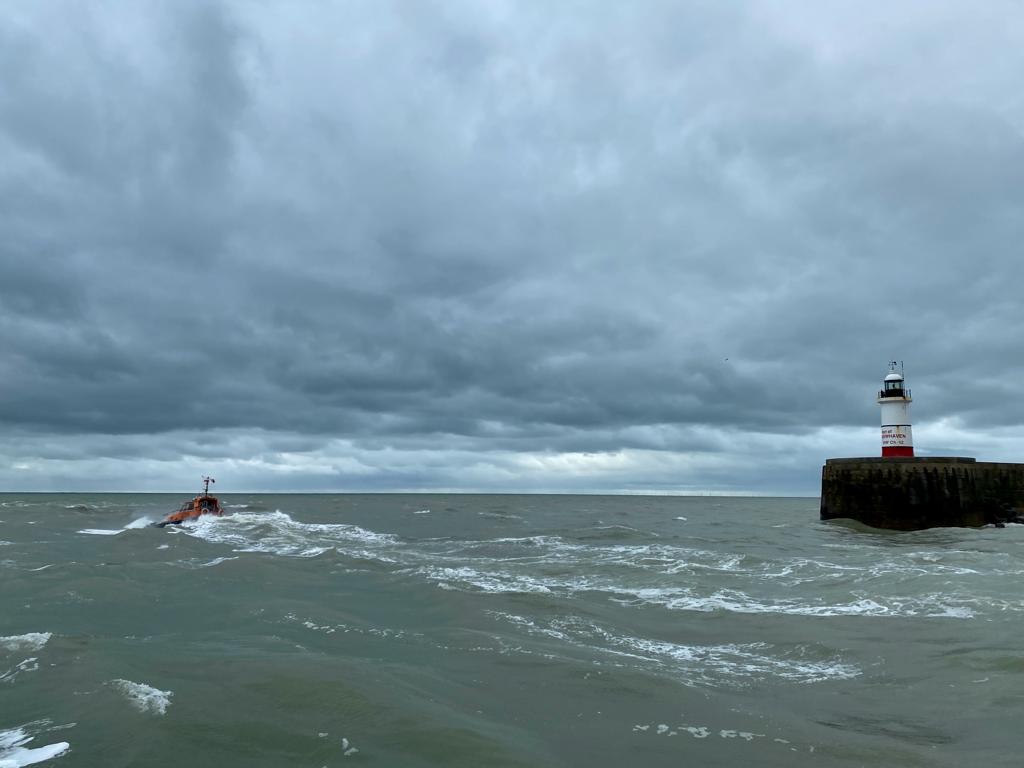 Newhaven Harbour Arm Lighthouse with the pilot boat heading out