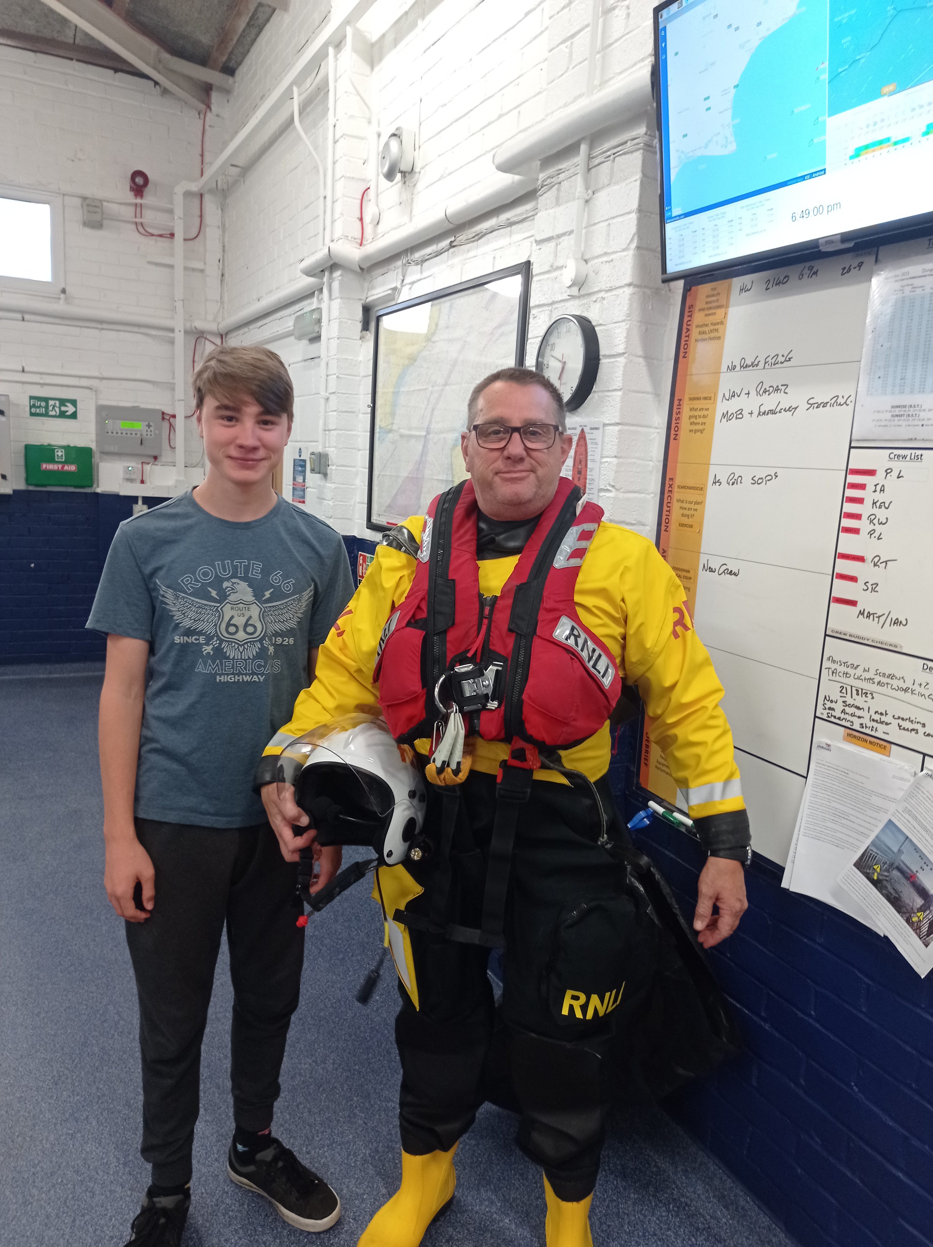 Samuel Leigh and father Peter in front of briefing board