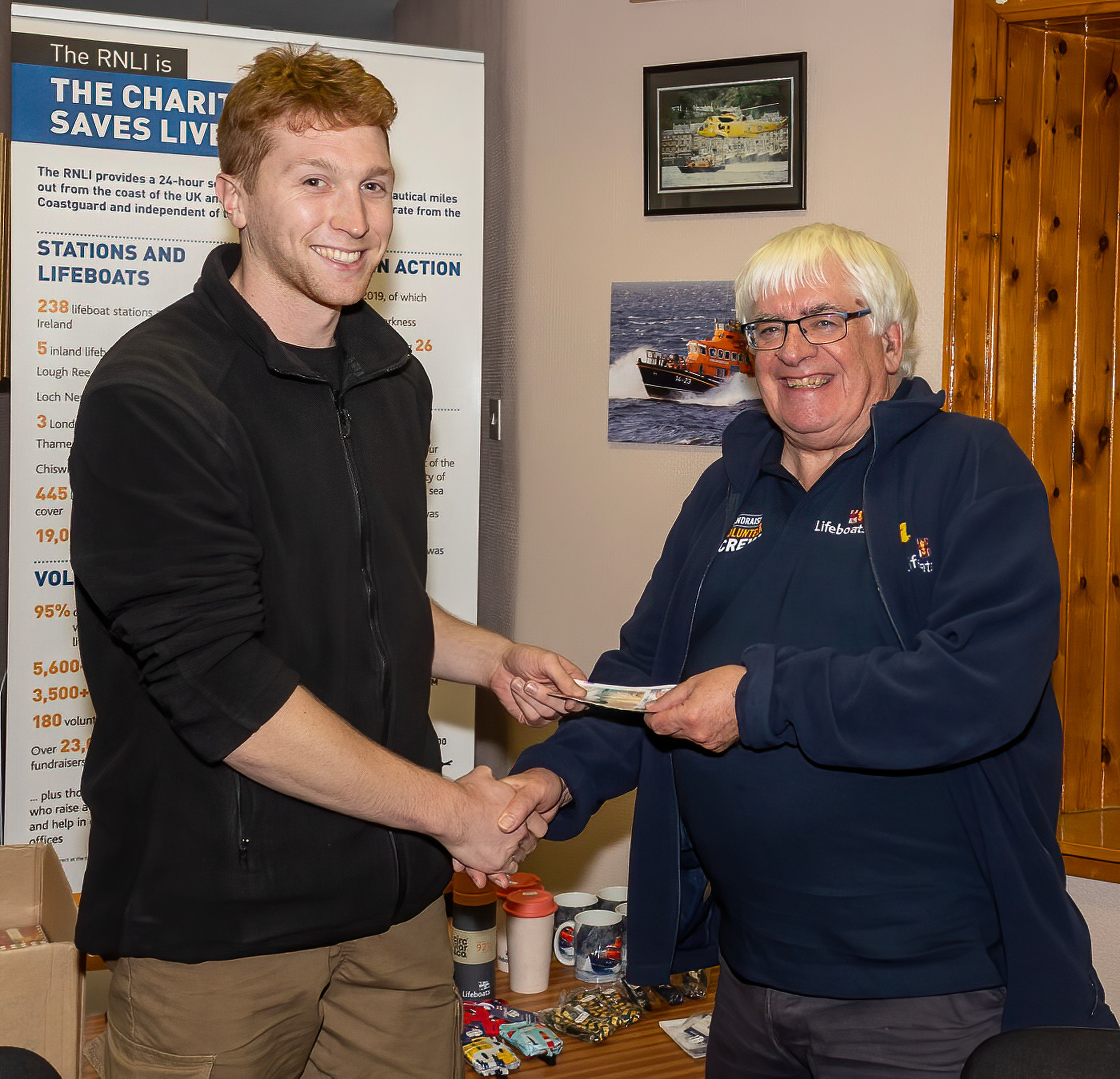SAMS student Merlin hands over a cheque to Treasurer Lachie.