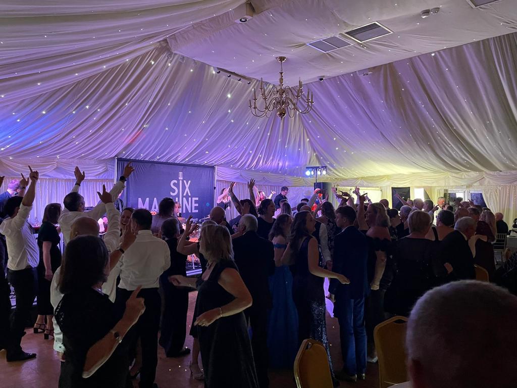 Guests dance to Six Machine party band