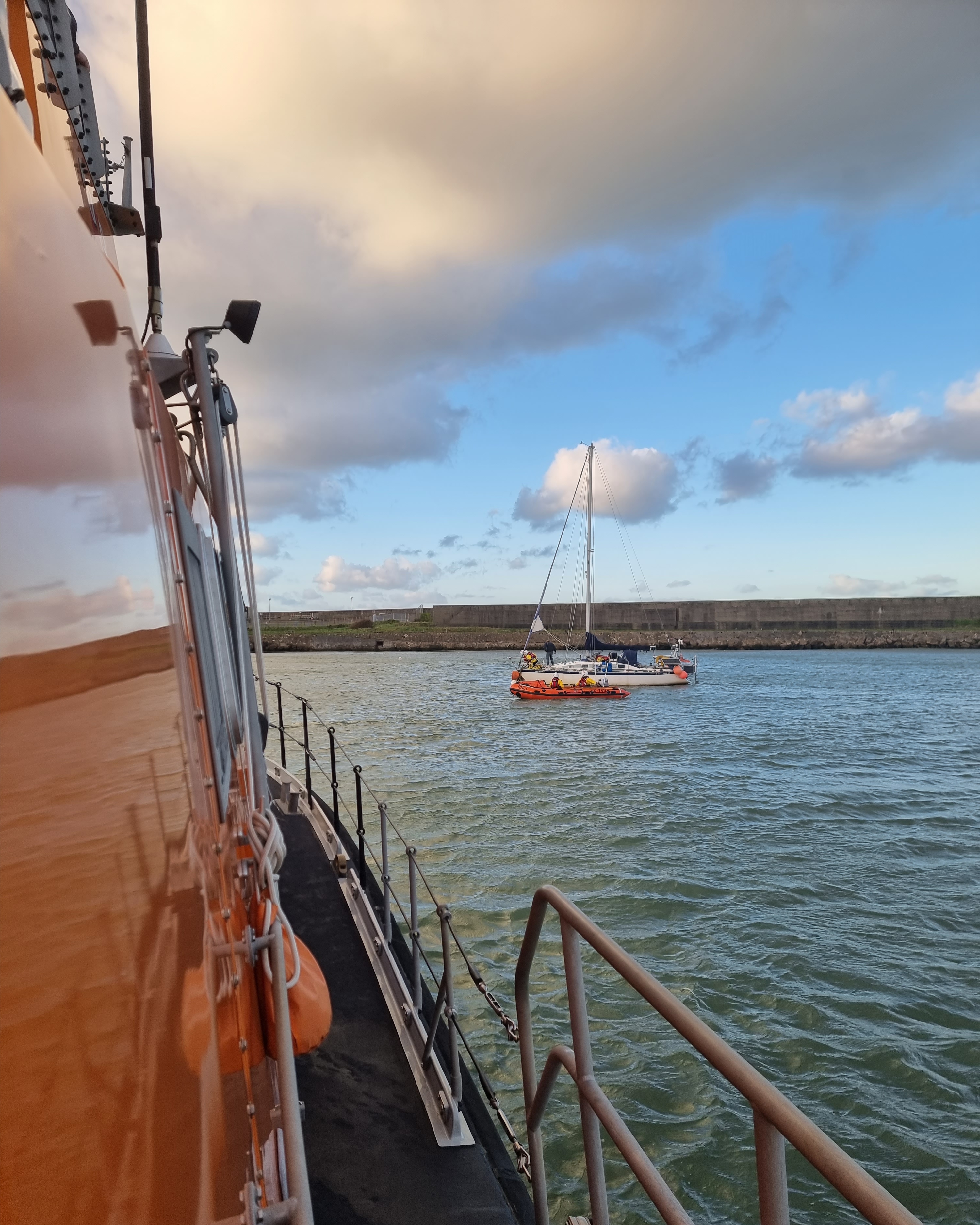 View from the all weather Trent class lifeboat Blue Peter VII of the D class inshore lifeboat Edward Arthur Richardson with casualty vessel in the background.