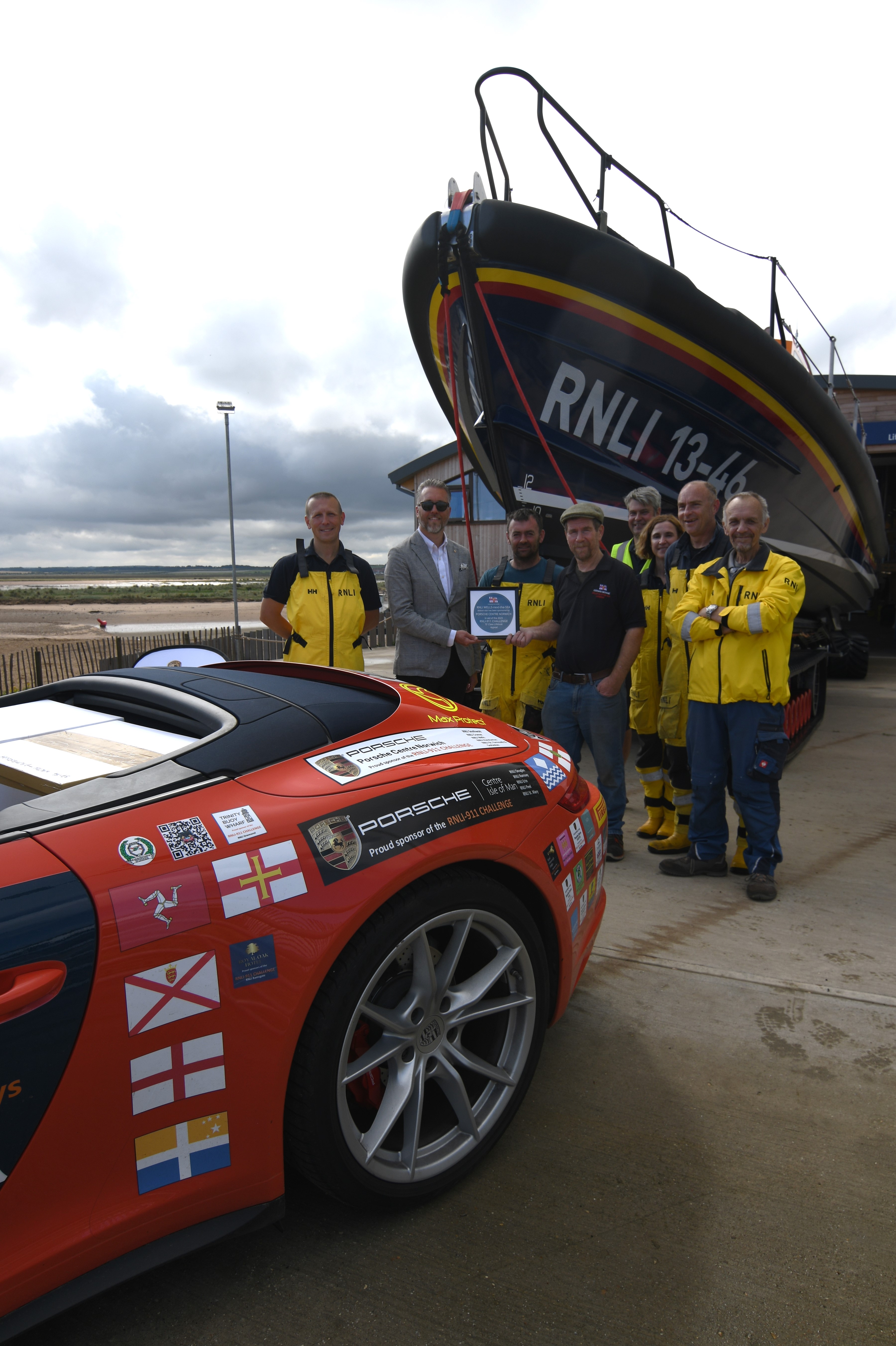 Wells RNLI played host to Belinda and James Richardson and their bright red Porsche 911, 'Splash', on Friday 1 September 2023.