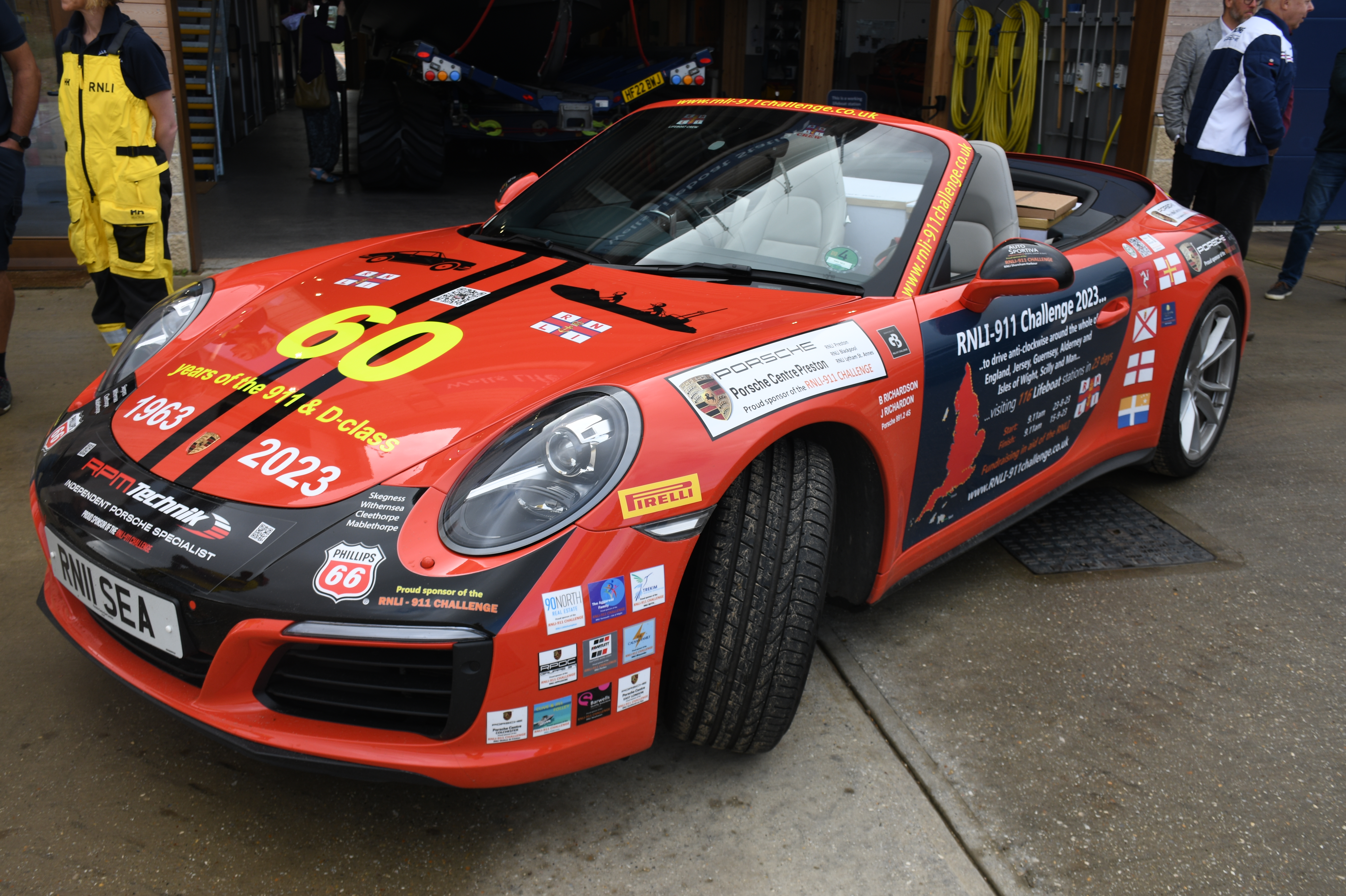 Wells RNLI played host to Belinda and James Richardson and their bright red Porsche 911, 'Splash', on Friday 1 September 2023 photo with Shannon 13-46 Duke of Edinburgh