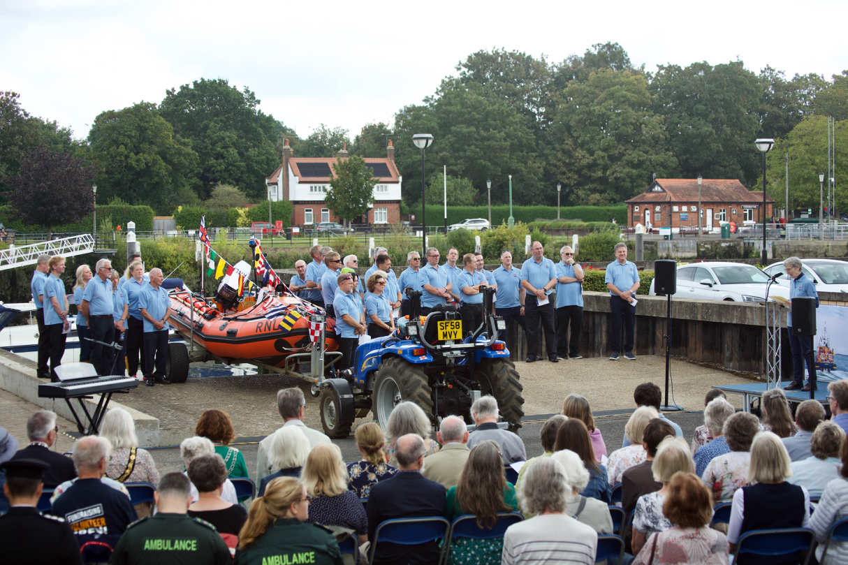 Volunteer Crew and guests gather round the lifeboat.