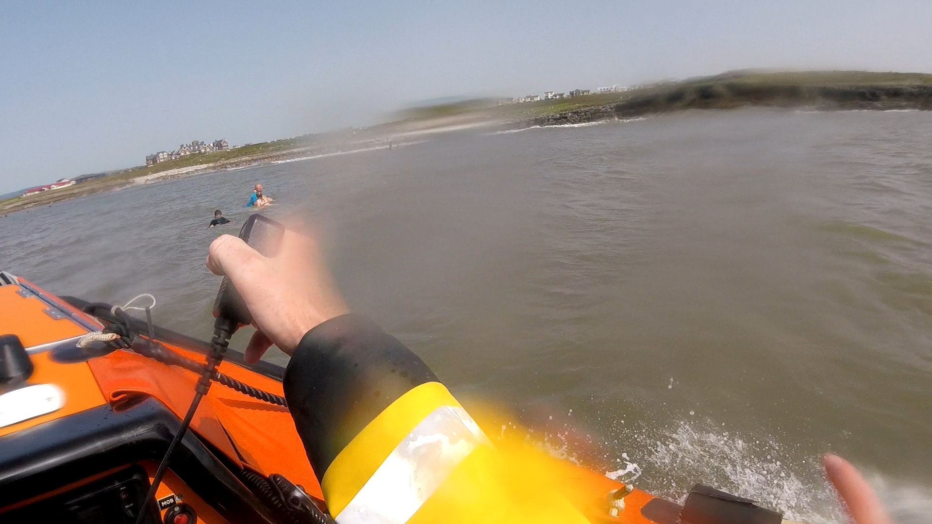 Swimmers cling to surf instructors board along with a body boarder