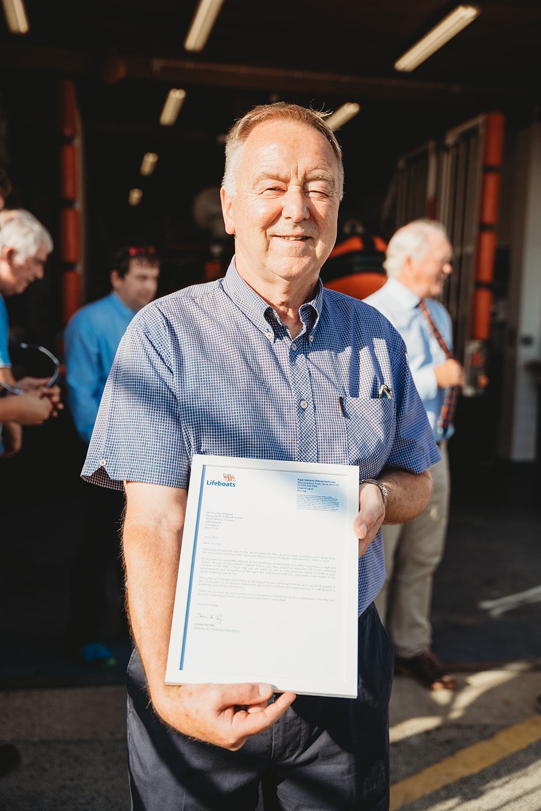 Aberystwyth Lifeboat Volunteer Tommy Ridgeway presented with letter of thanks.