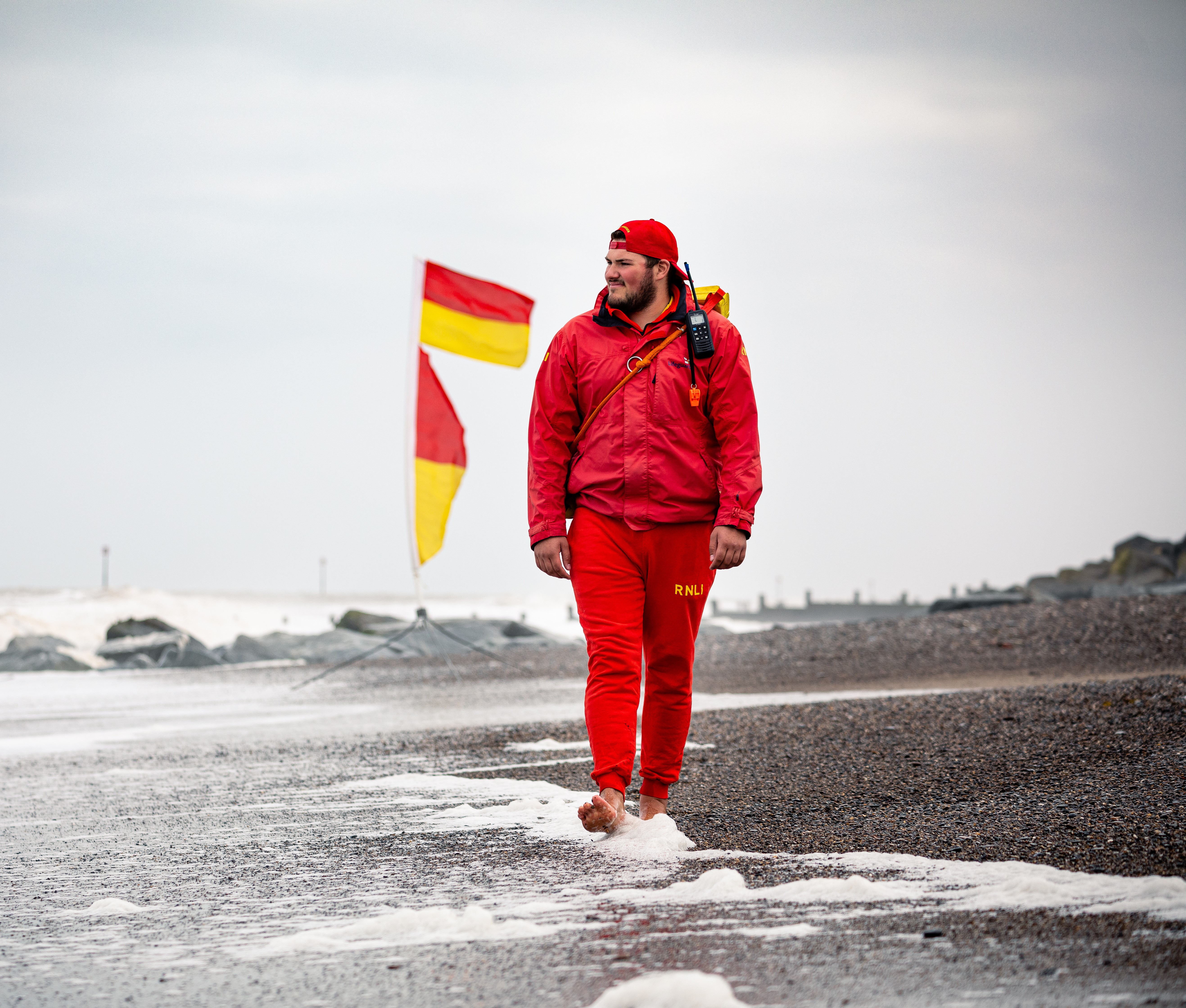 RNLI Lifeguard patrolling the beach at Withernsea