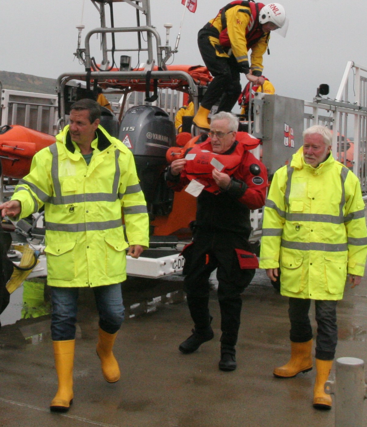 Rescued diver Jeff Everett is shown leaving Lyme Regis lifeboat after being rescued by the volunteer crew. Image supports the RNLI 200 Voices podcast for 18 Sept 23