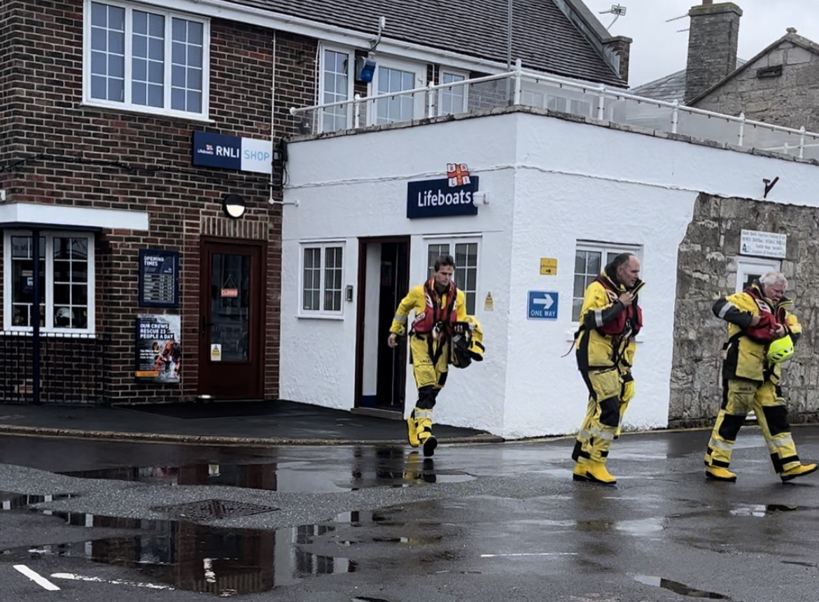 Photo of crew outside Yarmouth Lifeboat Station assembling for the shout.