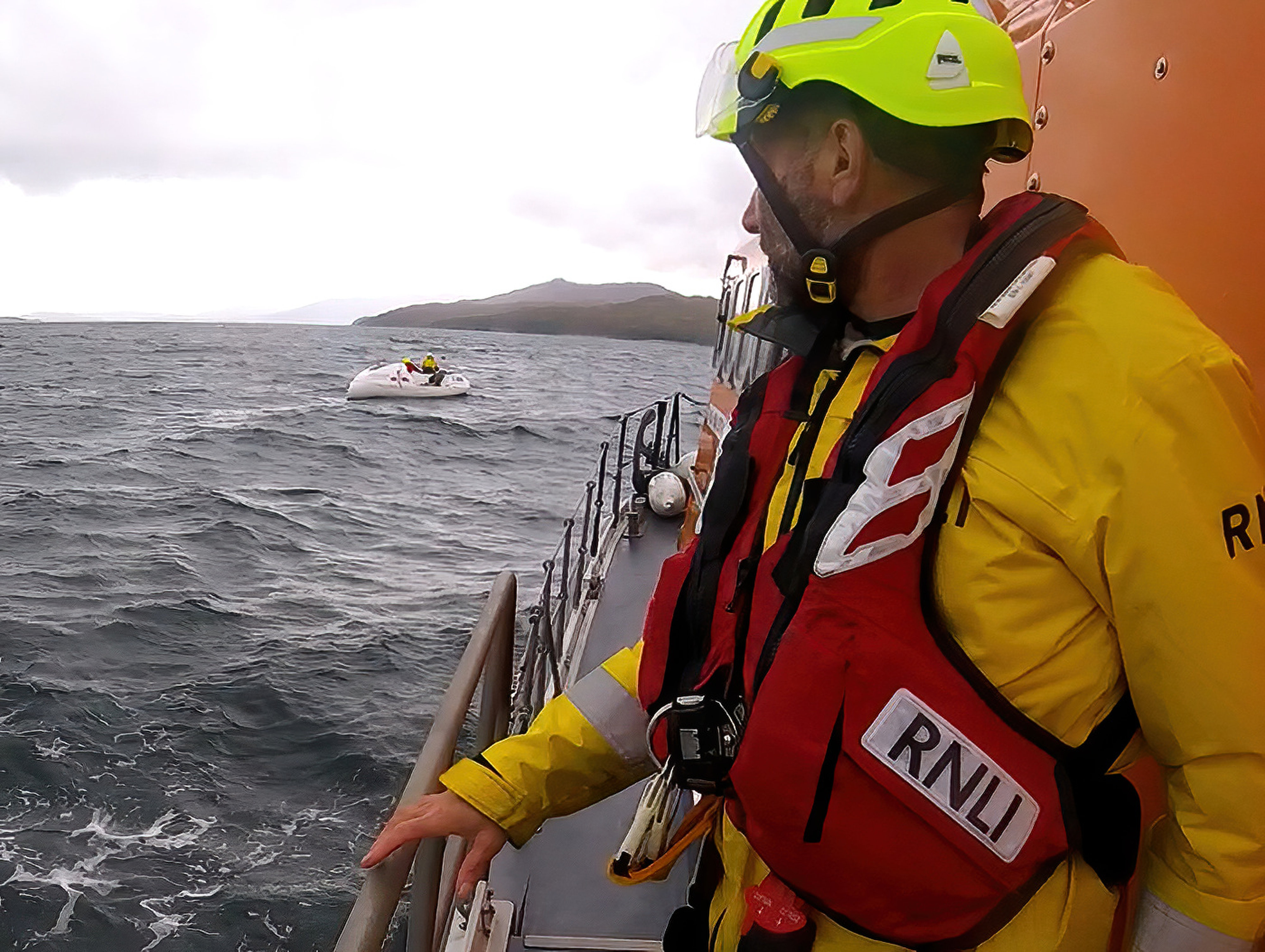 Crew preparing to take casualty vessel under tow.