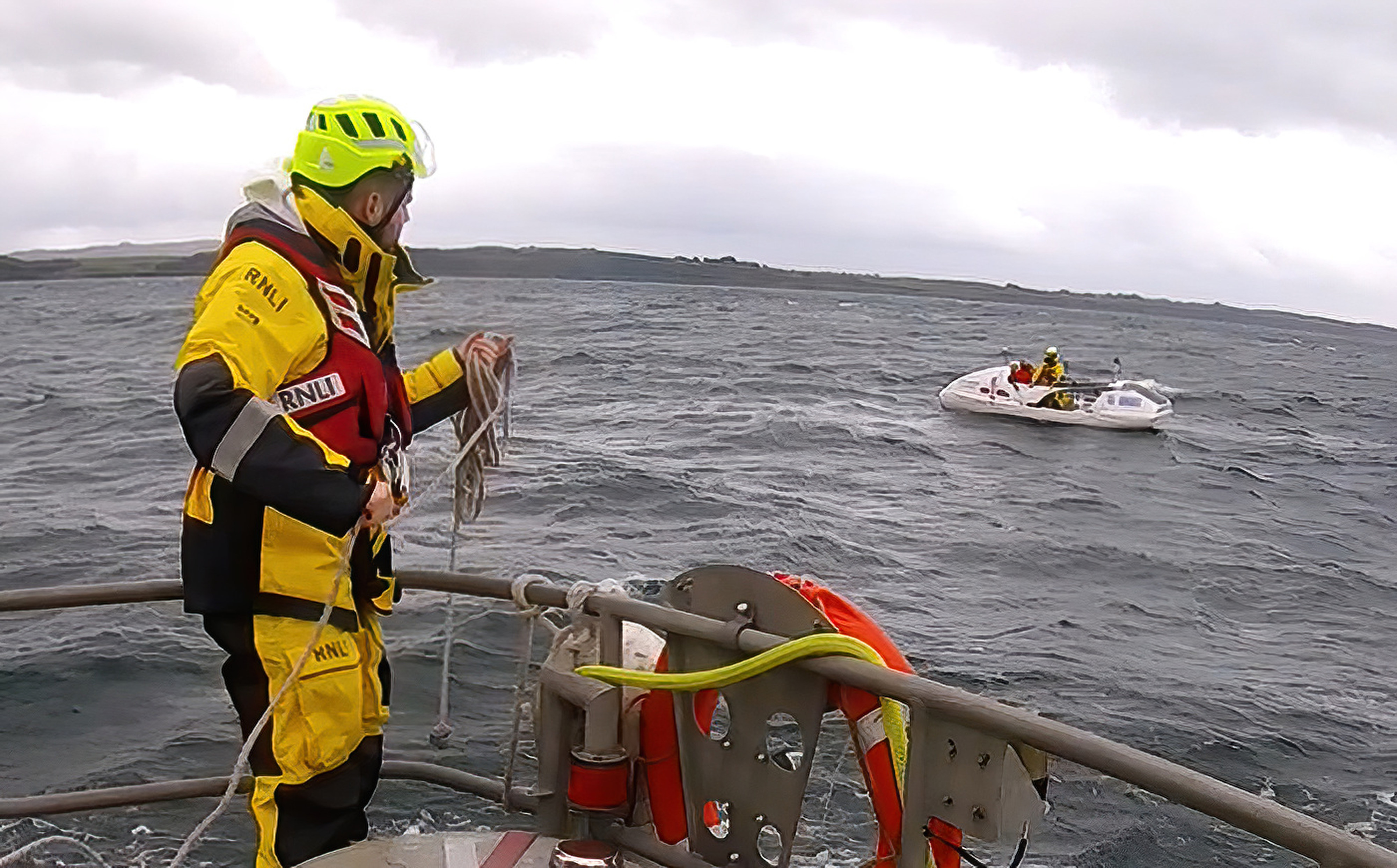 Crew preparing to take casualty vessel under tow.