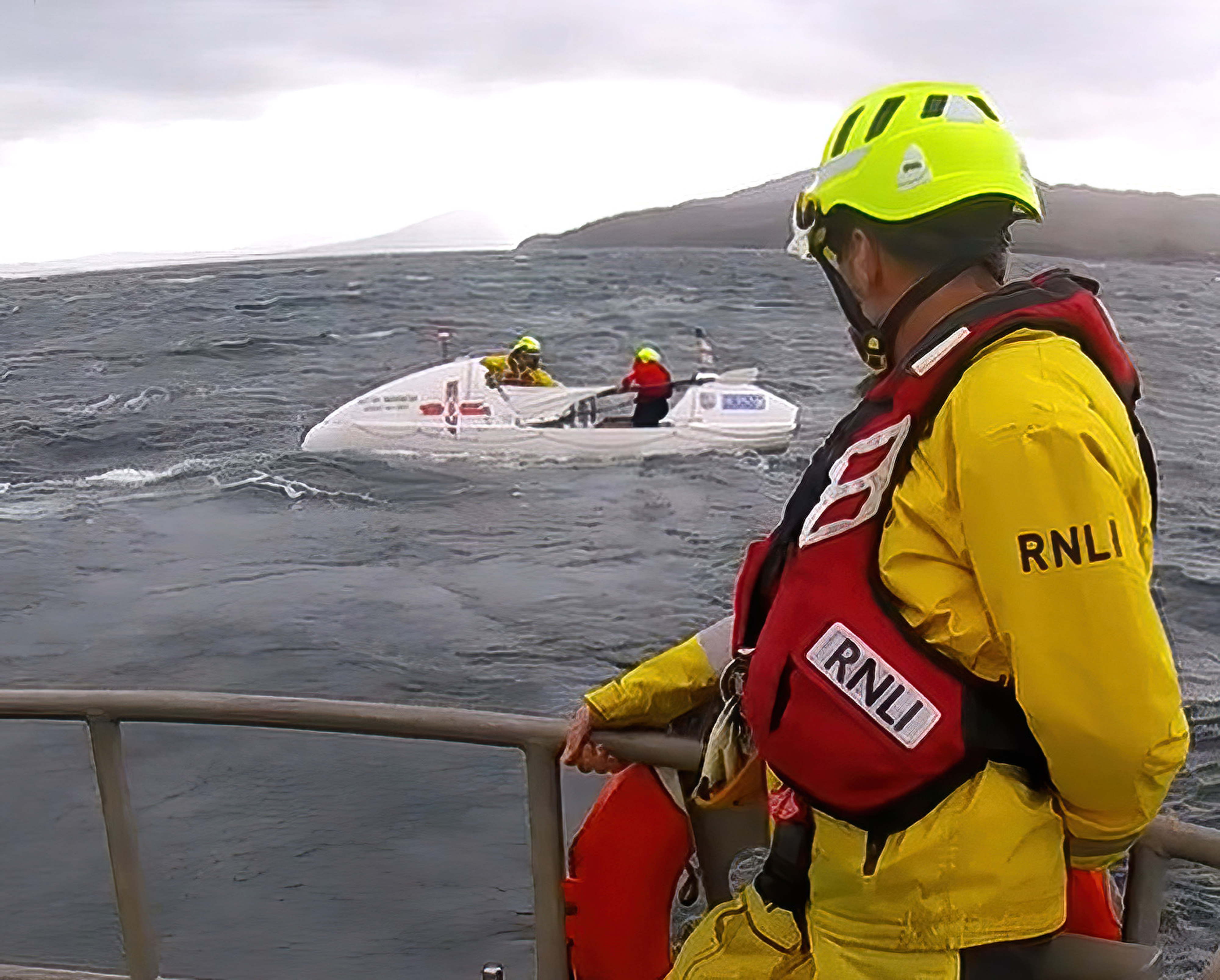 Crew preparing to take casualty vessel under tow.