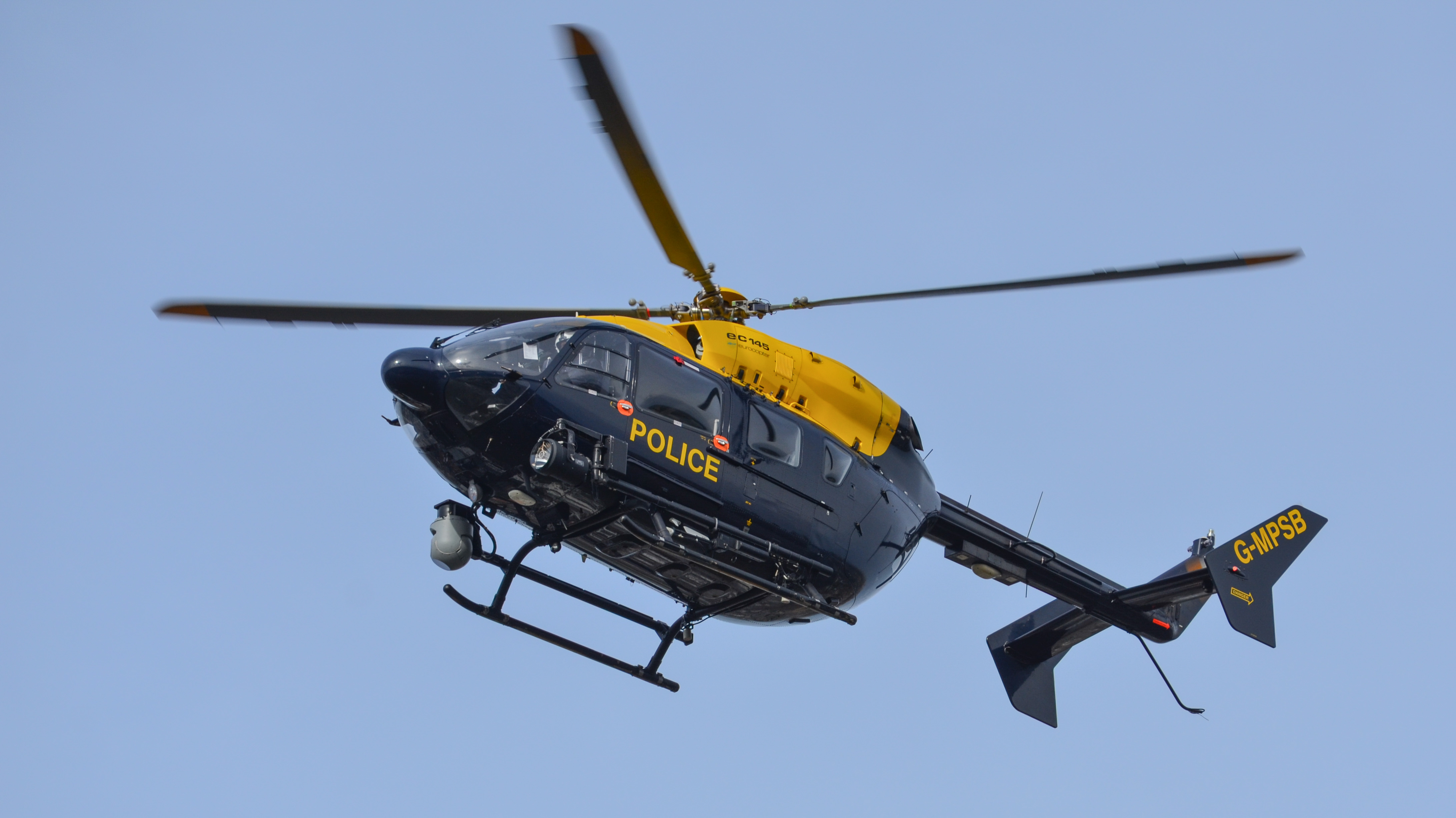 Low flying police helicopter searching from above