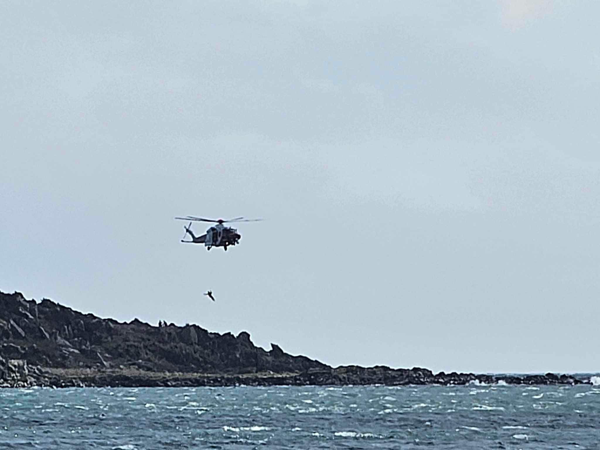 helicopter airlifting casualty above island