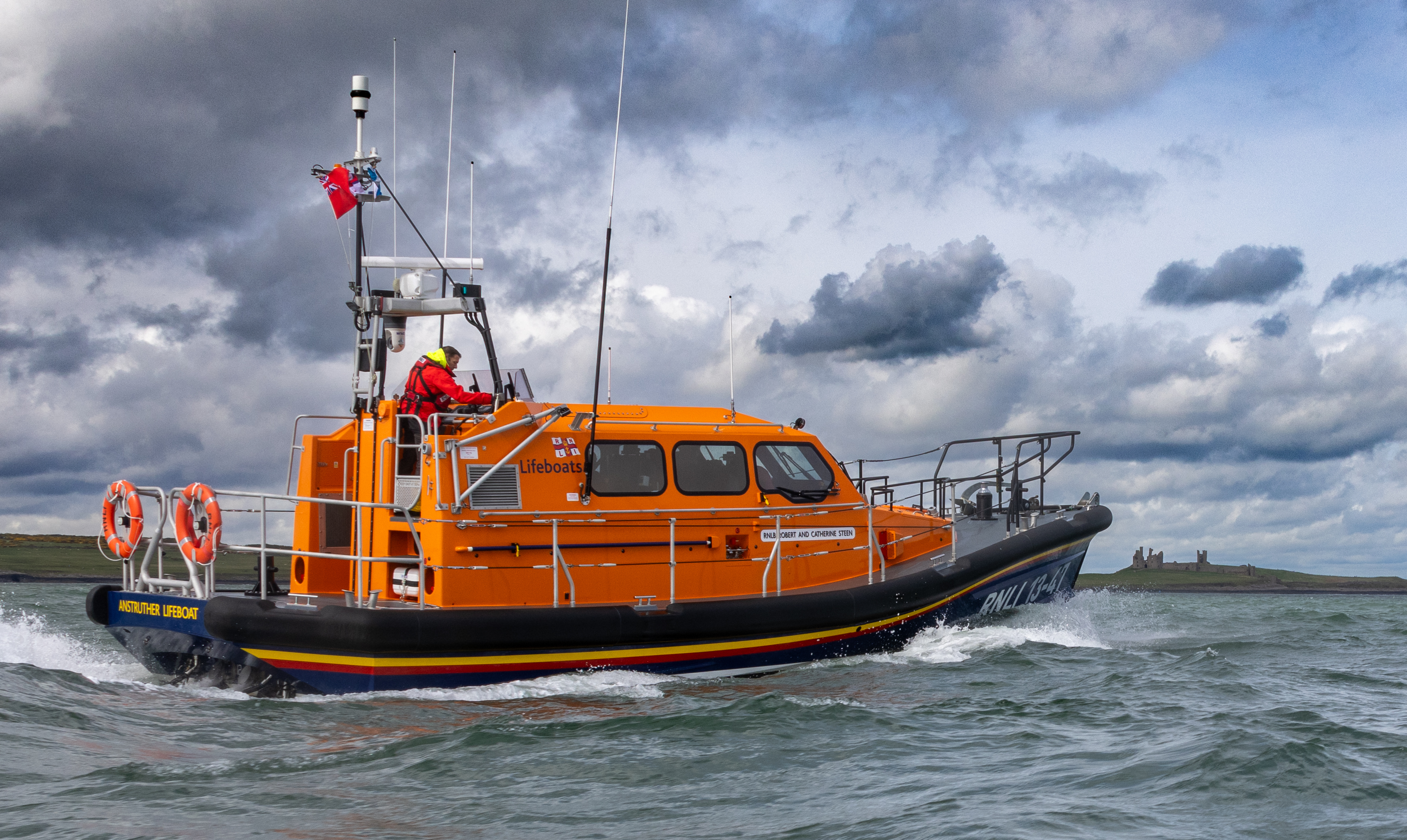 Lifeboat 13-47 passing Craster harbour, being escorted by Craster Lifeboat D838
