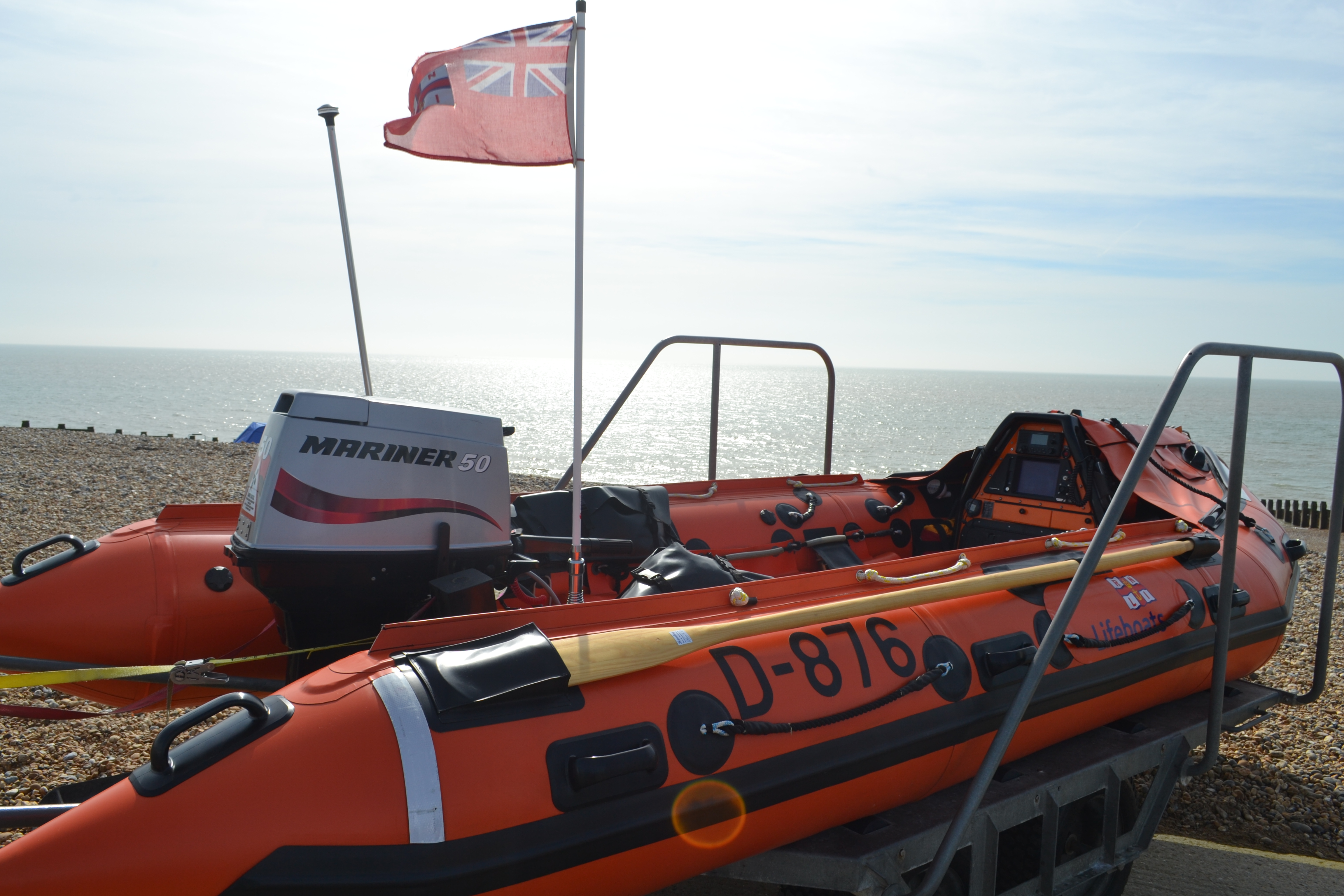 D Class inshore lifeboat on trailer with sea behind