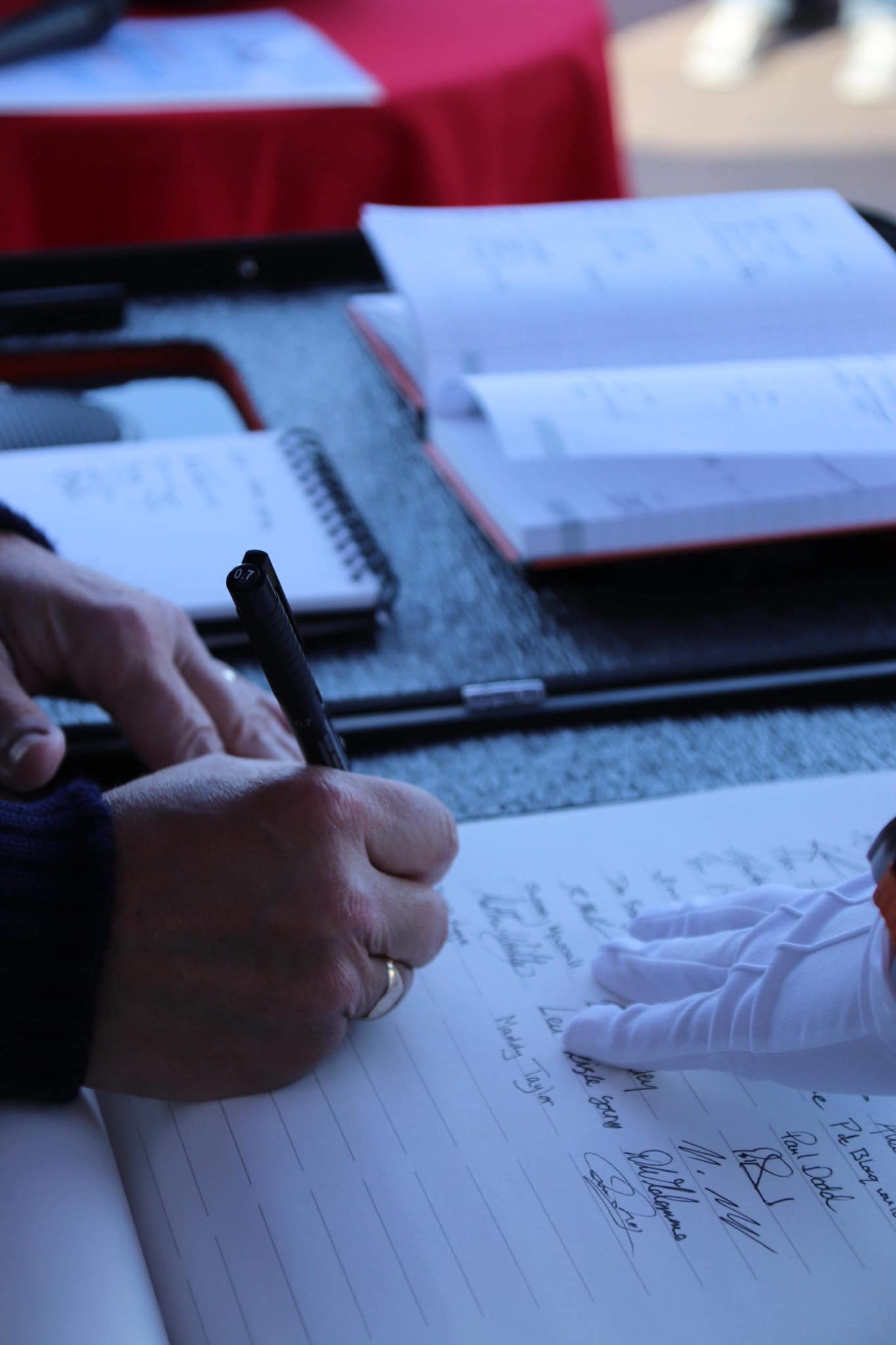 Chairman Richard Newton signs the Scroll