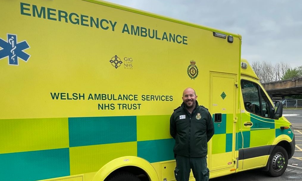 James King standing beside a Welsh Ambulance Service vehicle